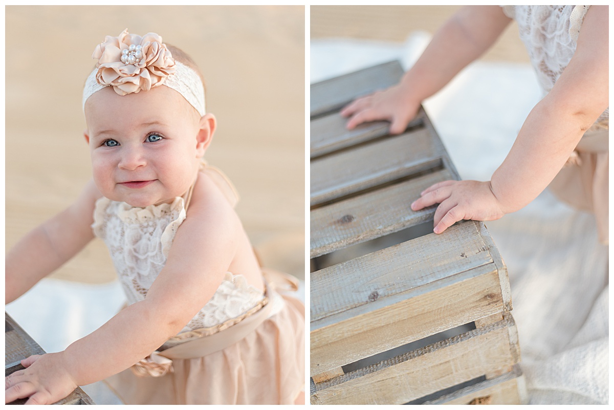 Baby girl leaning on a crate at the beach for her cake smash portraits in North Dallas by Lindsey Dutton Photography, a Dallas Cake Smash Photographer. 