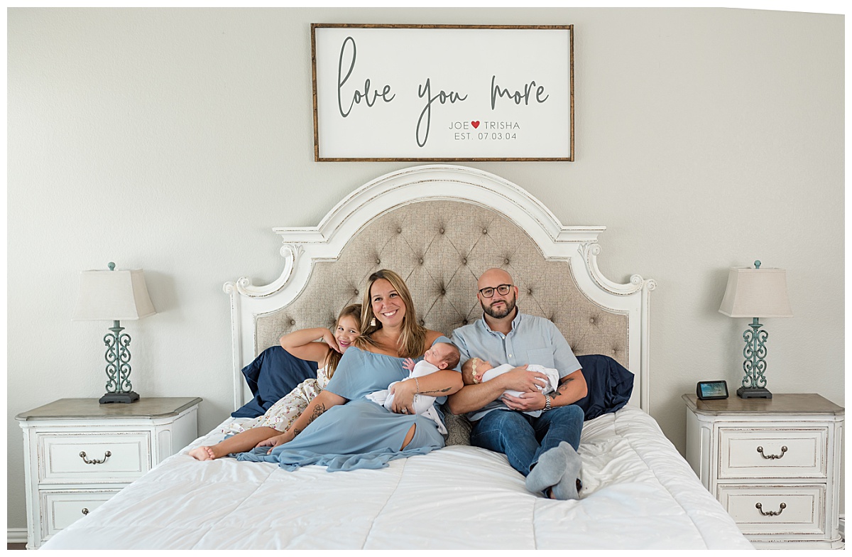 Family of five sits on the bed for their in-home twin newborn session taken by Lindsey Dutton Photography, a Dallas Newborn Photographer.