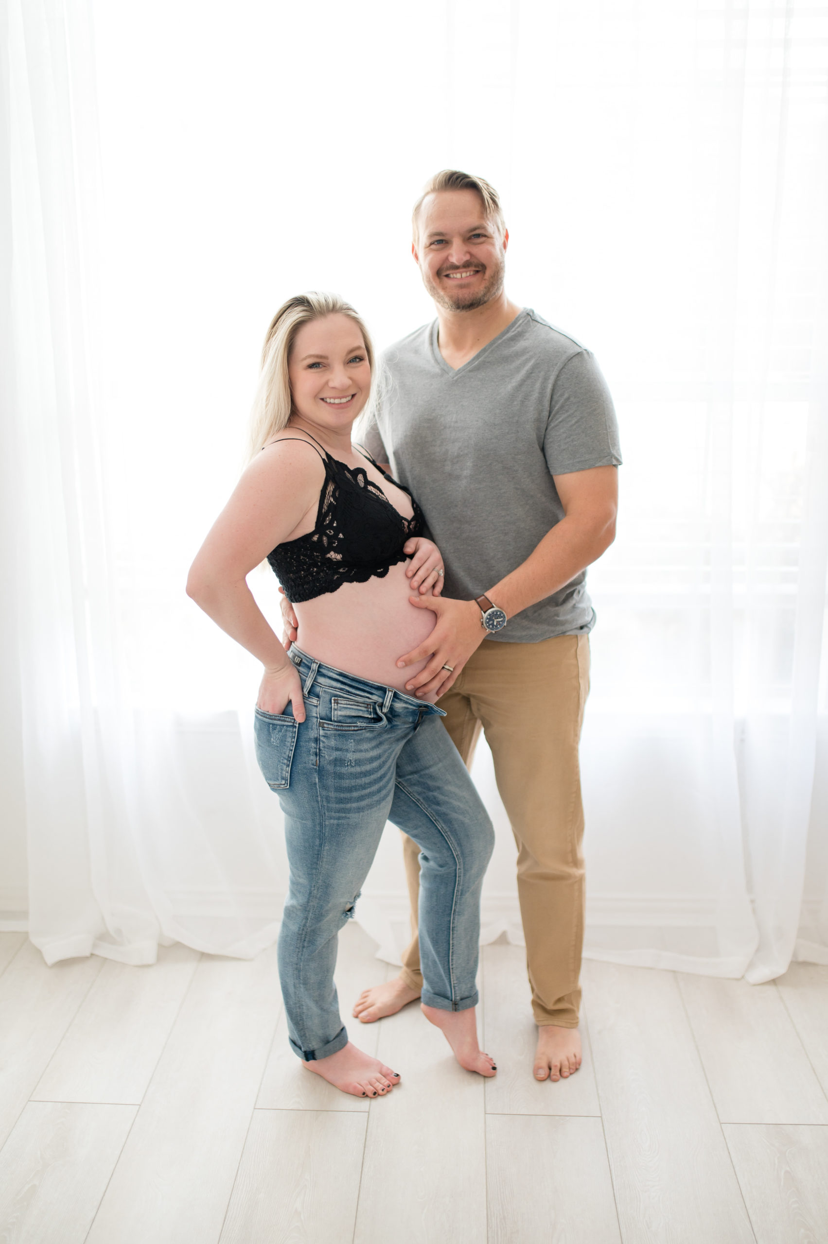 Husband and wife in causal clothes in studio maternity in dallas texas 