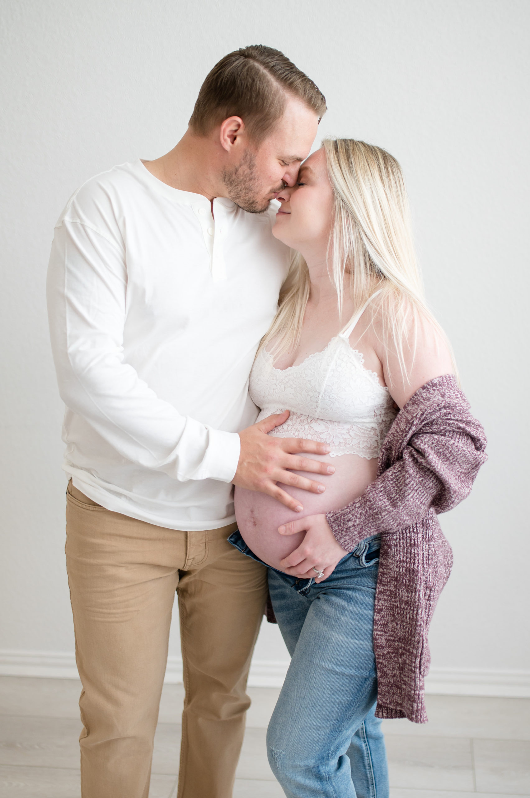 husband and wife lovingly embrace during maternity session in dallas texas 