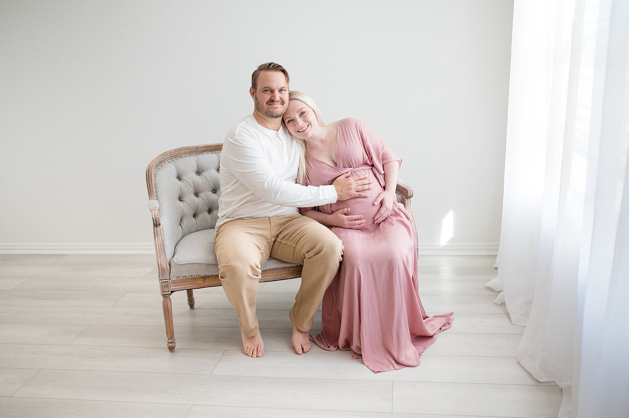 parents to be snuggling on couch photographed by Dallas newborn photographer, Lindsey Dutton Photography