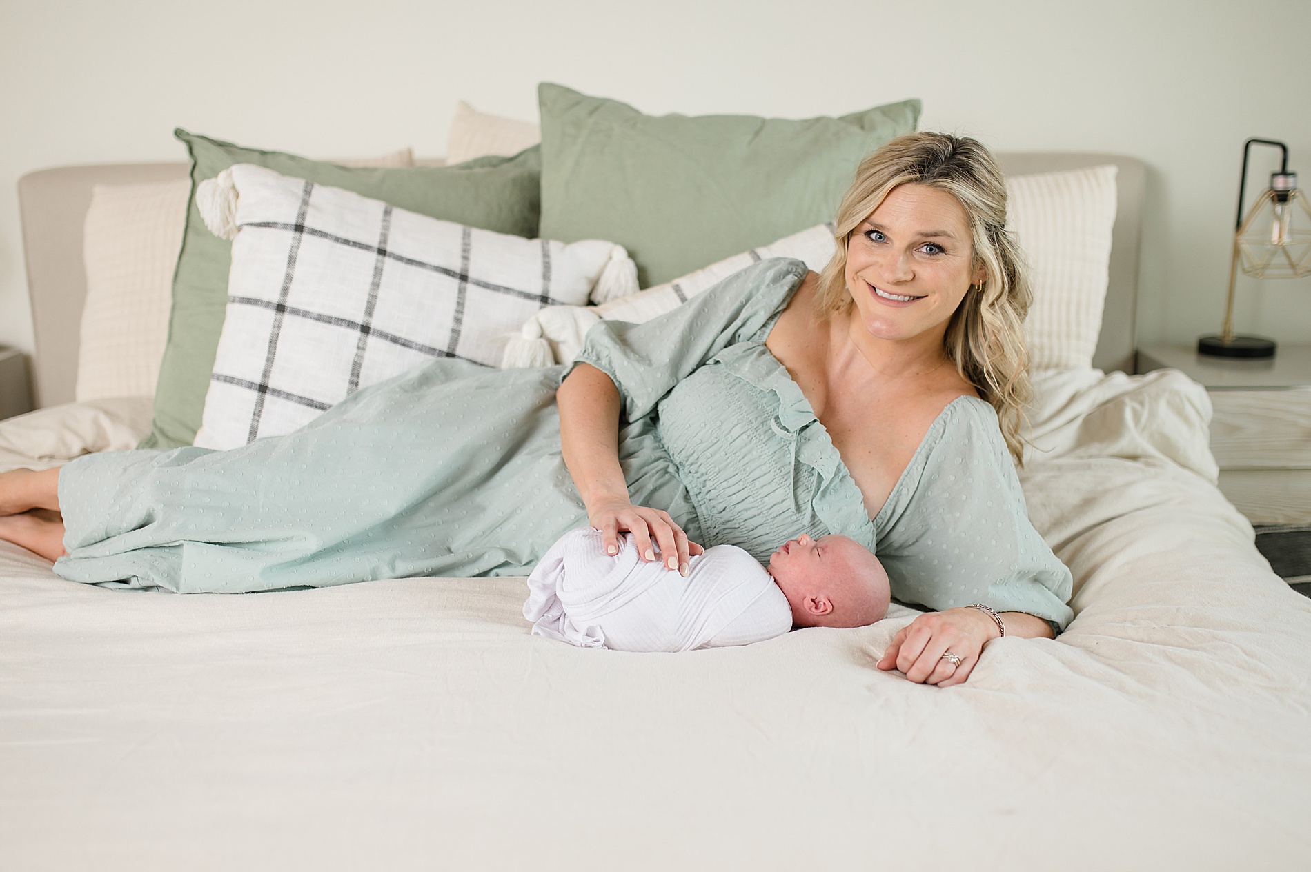 mom lays with her newborn son taken by Dallas Newborn photographer, Lindsey Dutton Photography
