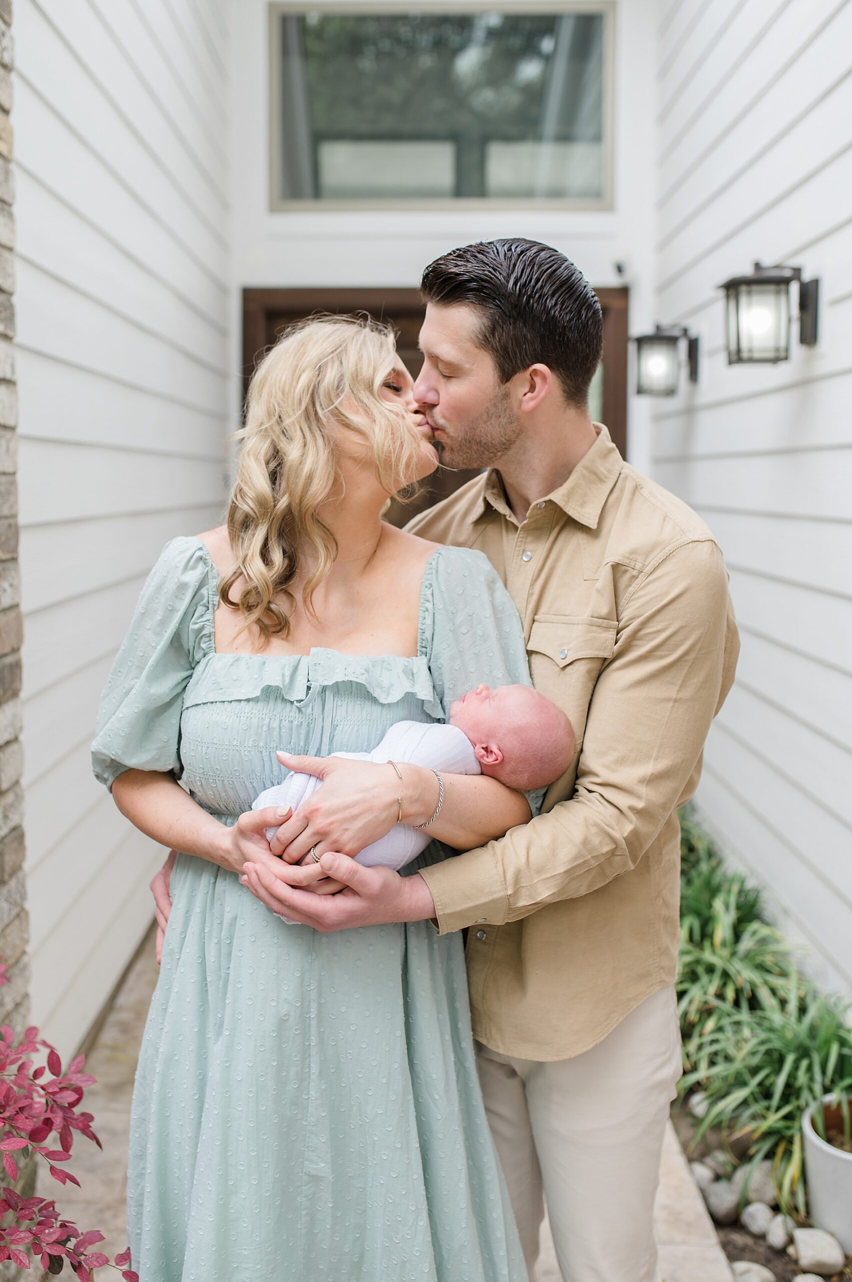 new family of three outside Texas home during Cozy In-Home Newborn Session photographed by Lindsey Dutton Photography, a Dallas Newborn photographer

