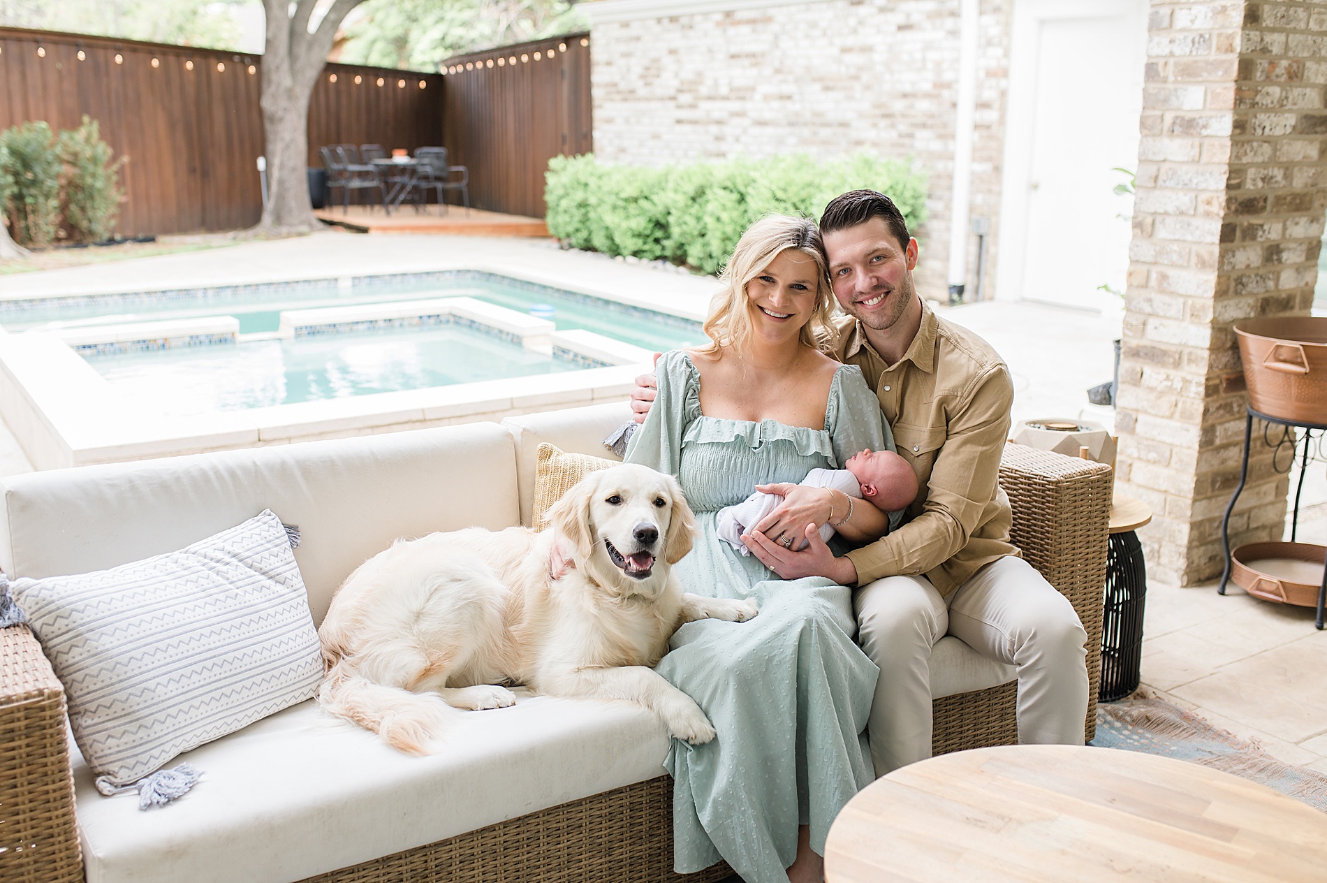 new parents hold son on back porch of home taken by Dallas Newborn photographer, Lindsey Dutton Photography

