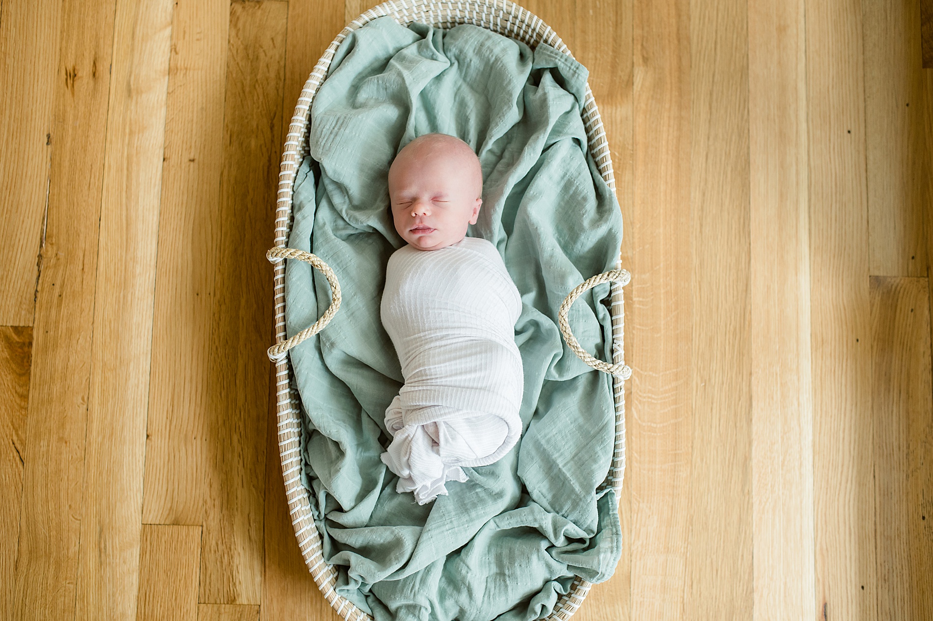 baby boy swaddled in blanket sleeps during Cozy In-Home Newborn Session photographed by Lindsey Dutton Photography, a Dallas Newborn photographer
