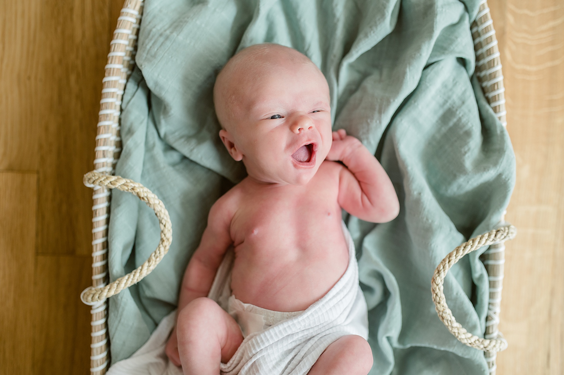 newborn boy yawns during Cozy In-Home Newborn Session photographed by Lindsey Dutton Photography, a Dallas Newborn photographer
