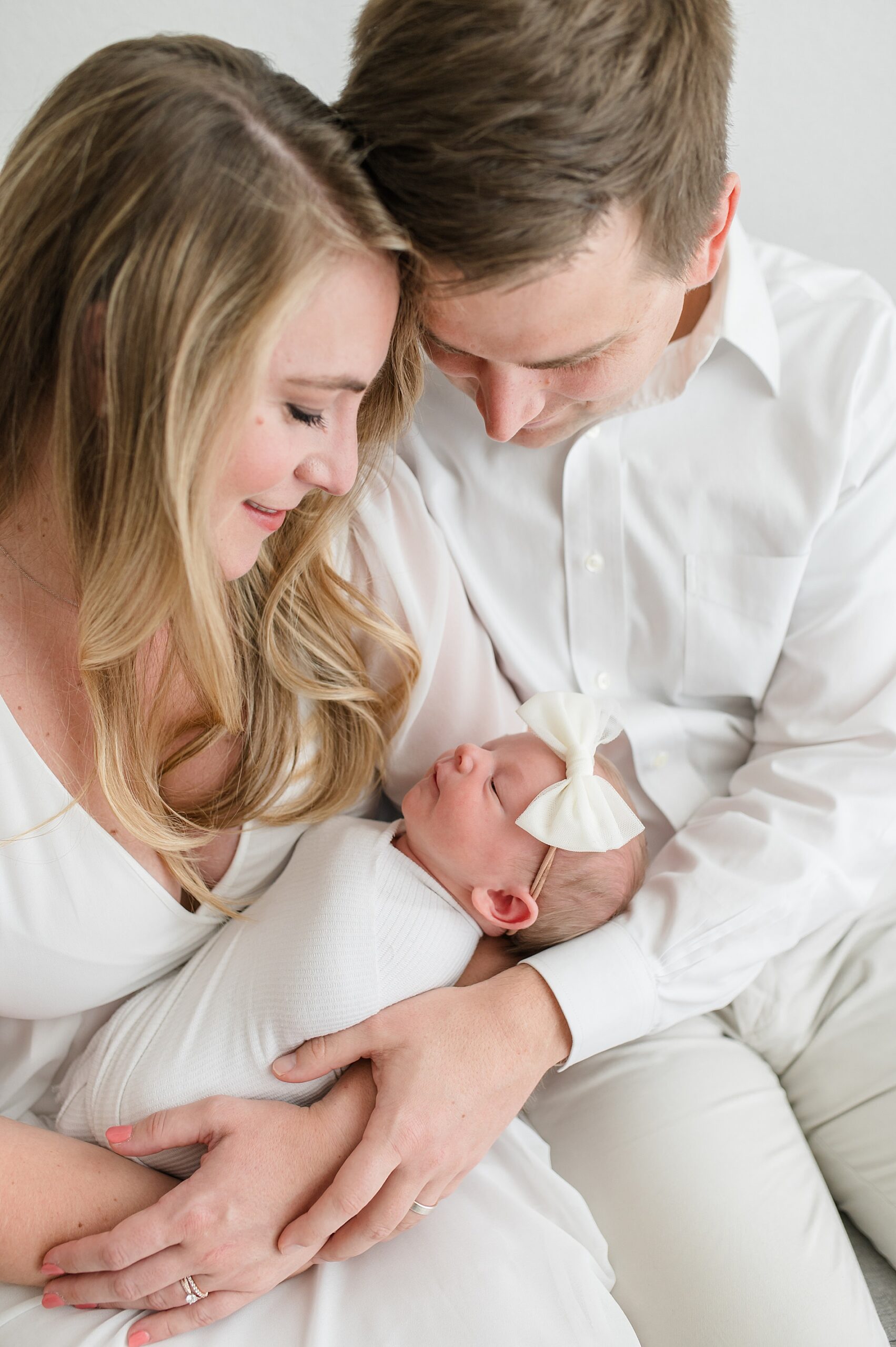 new parents look down at newborn photographed by Lindsey Dutton Photography, a Dallas Newborn Photographer 