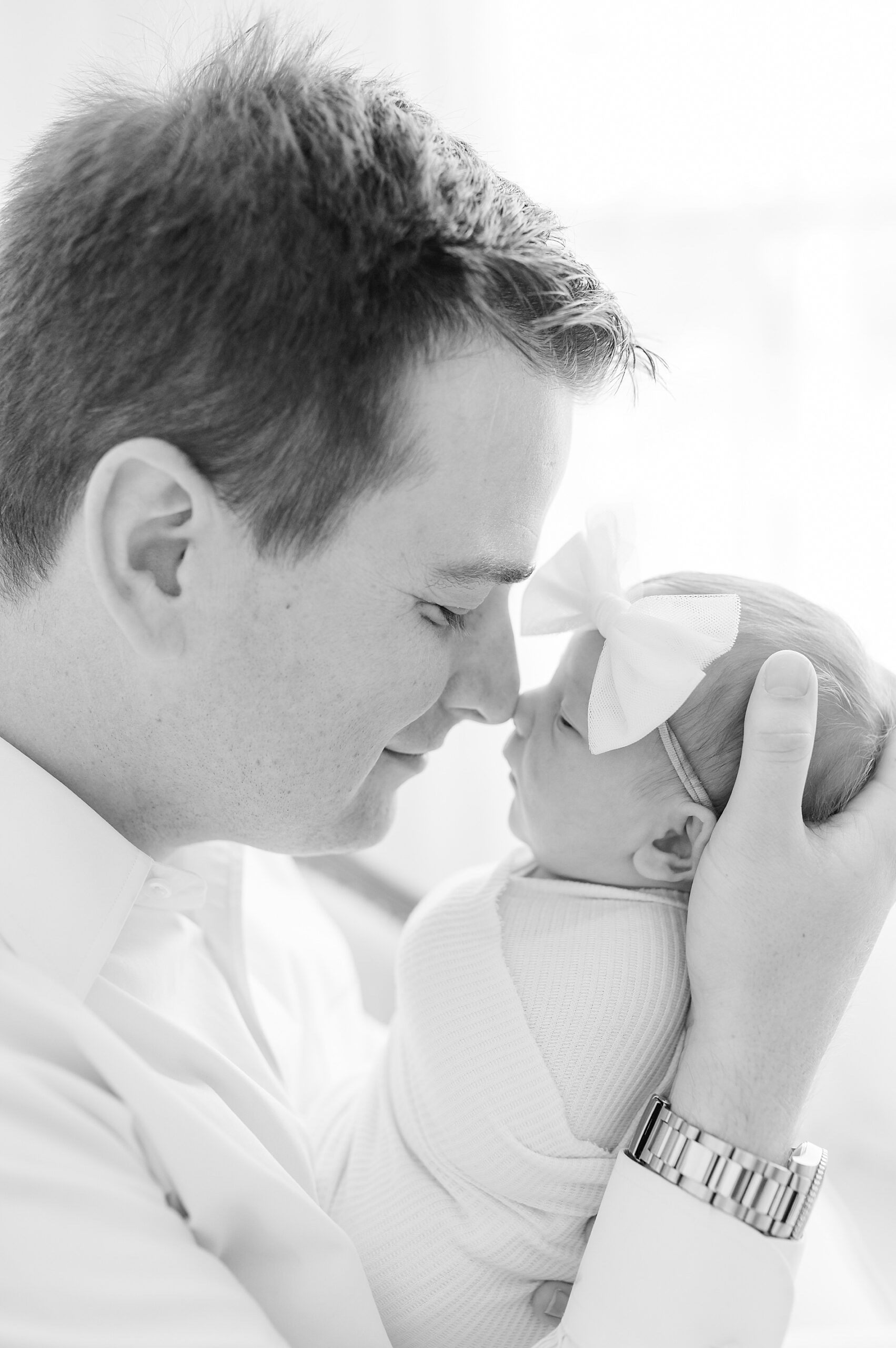 dad holds newborn girl photographed by Lindsey Dutton Photography, a Dallas Newborn Photographer 