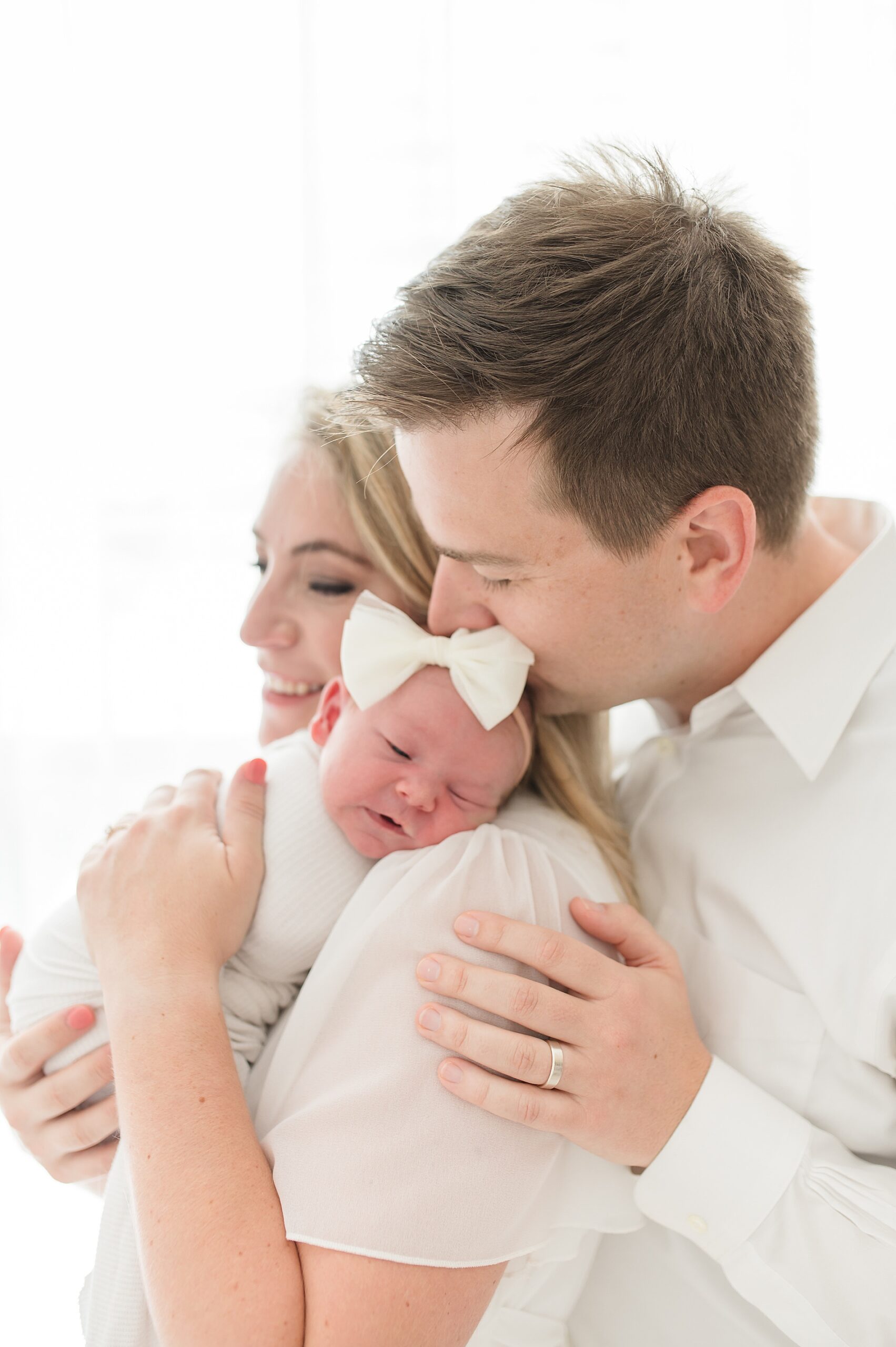 parents hold newborn girl during studio newborn session by Dallas Newborn Photographer, Lindsey Dutton Photography