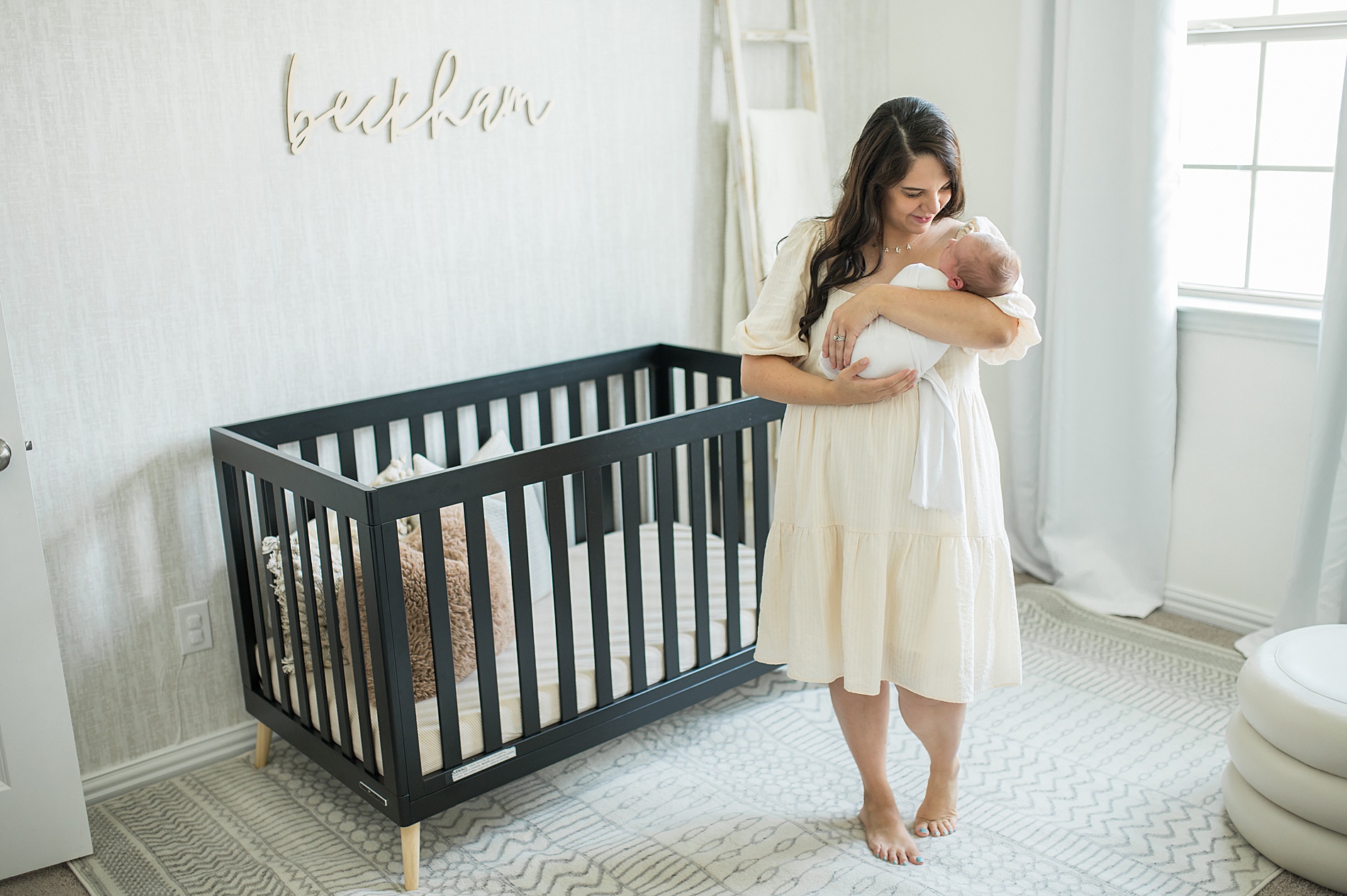mom holds newborn in nursery photographed by Lindsey Dutton Photography, Dallas Newborn photographer