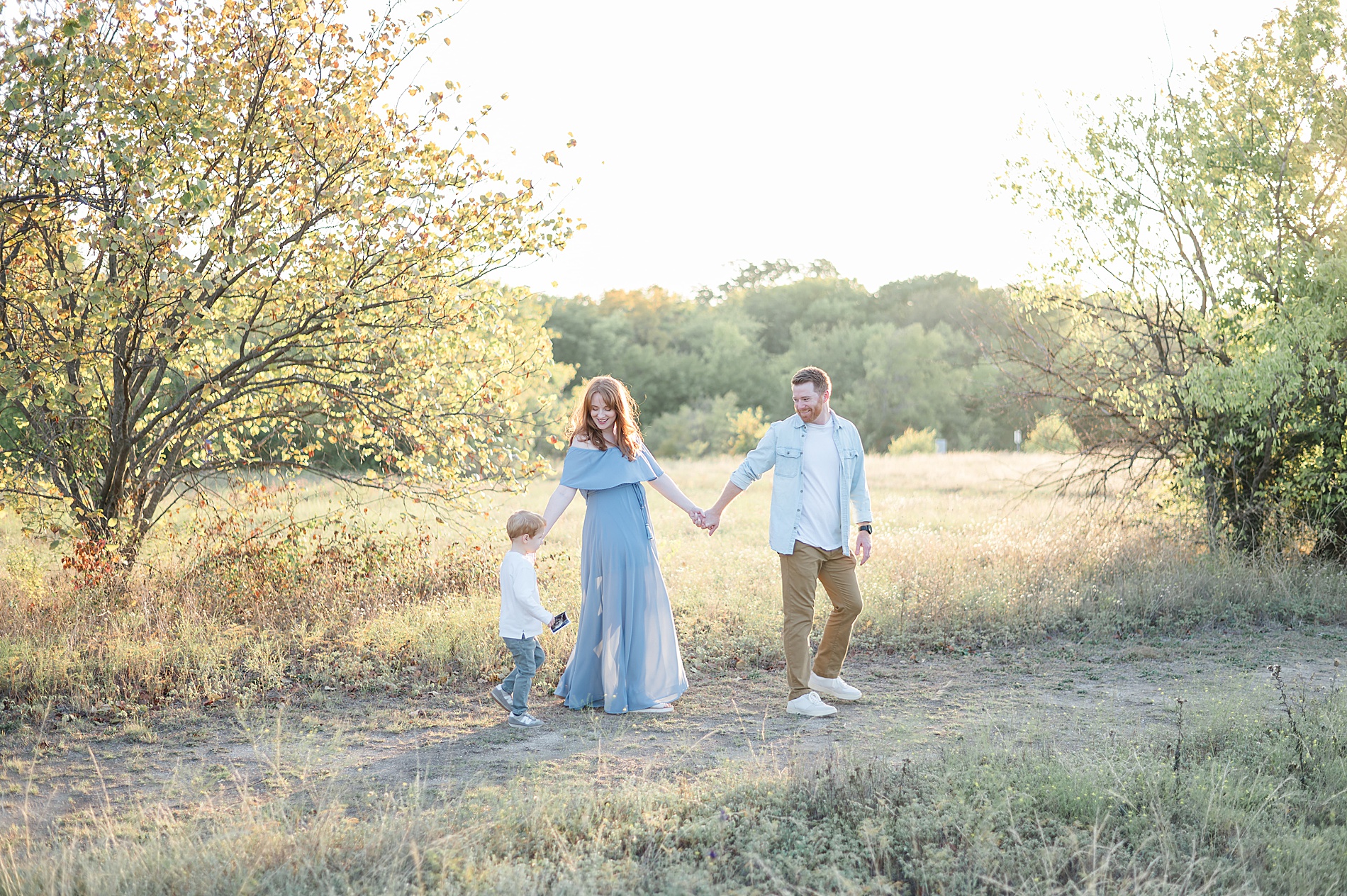 family of three during family portraits at Frisco Commons Park photographed by Lindsey Dutton Photography, a Dallas Family photographer
