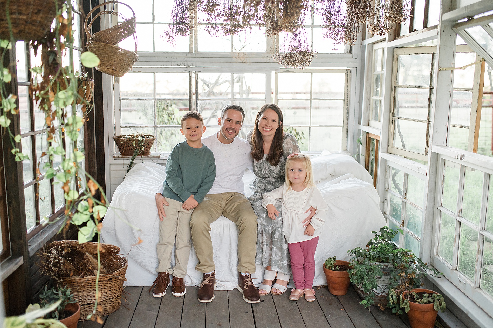 Family portraits inside greenhouse photographed by Lindsey Dutton Photography, a Dallas Family photographer
