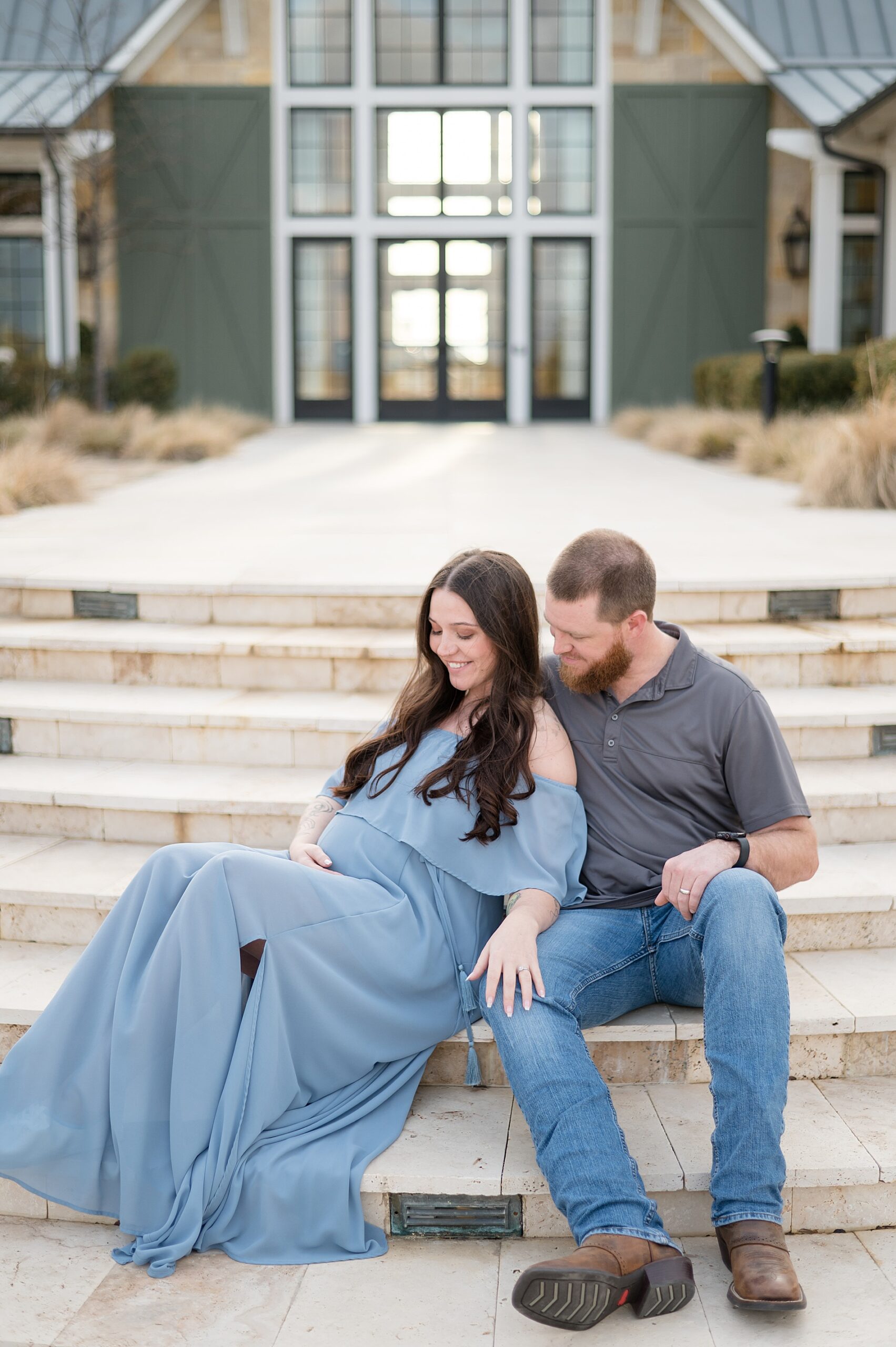 couple sit on stairs of Carriage house in Aubrey TX photographed by Lindsey Dutton Photography, a Dallas maternity photographer