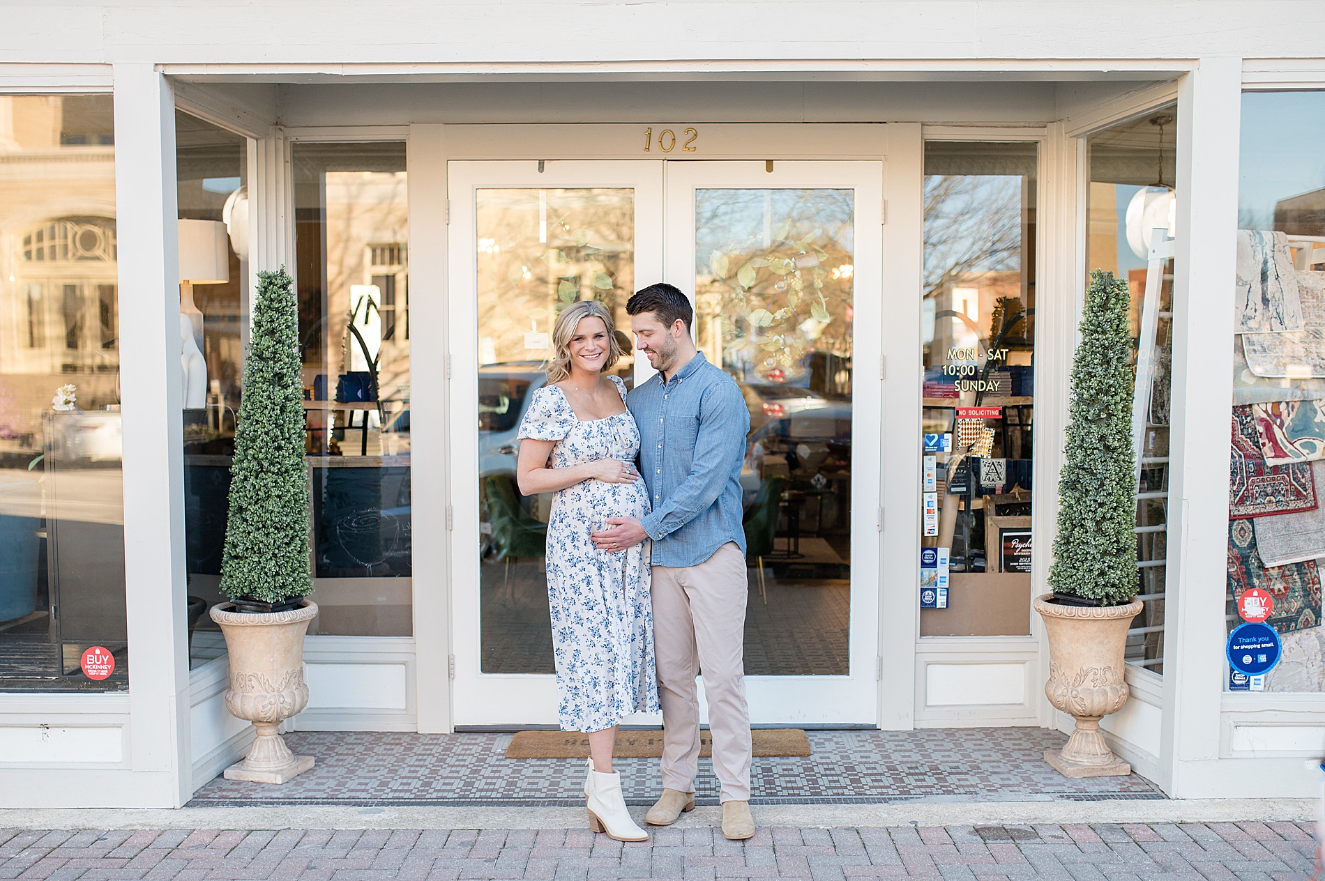 couple in front of shop in downtown McKinney photographed by Lindsey Dutton Photography, a Dallas Family photographer
