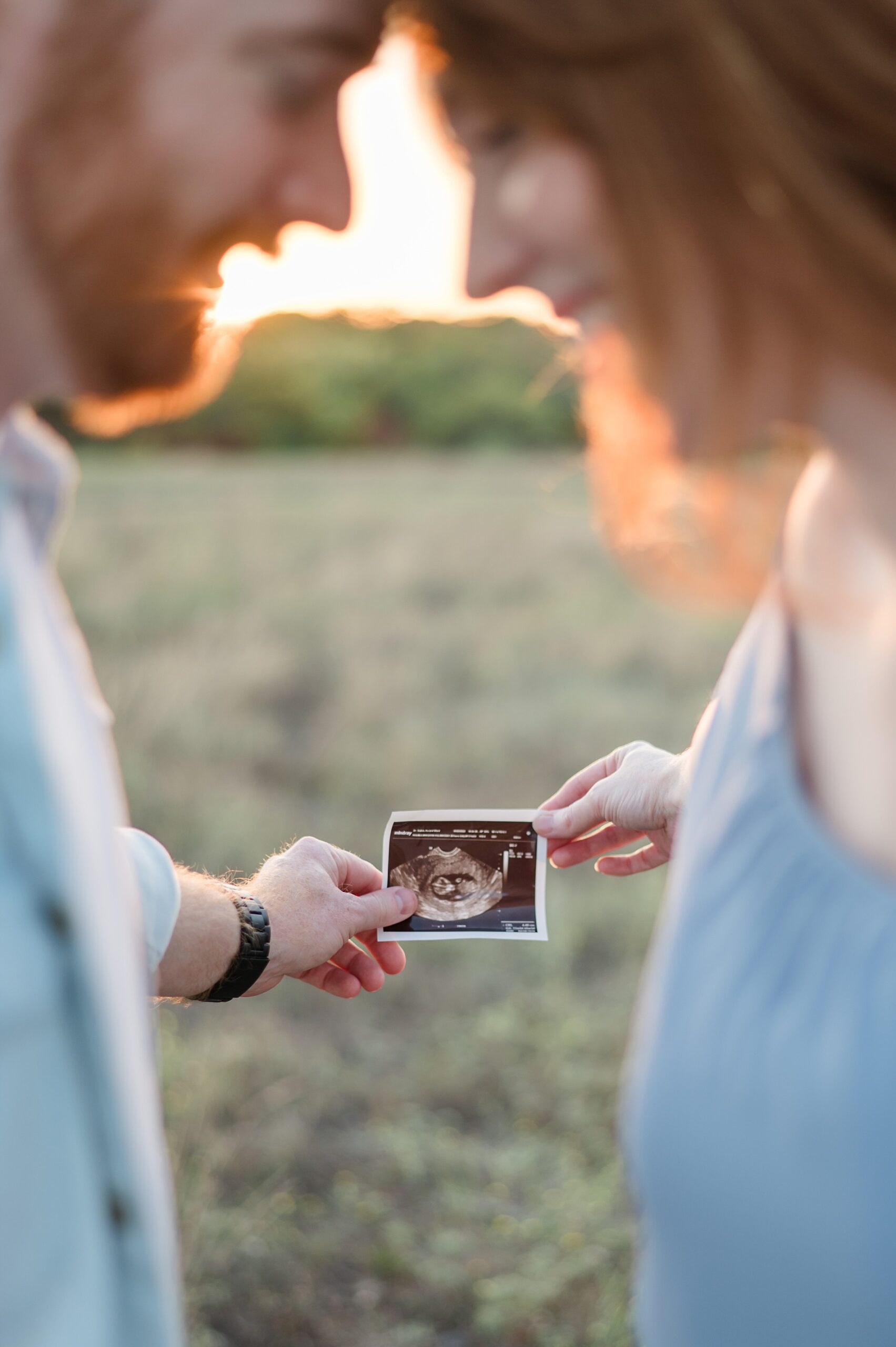 parents to be holding an ultrasound photo photographed by Lindsey Dutton Photography, a Dallas maternity photographer
