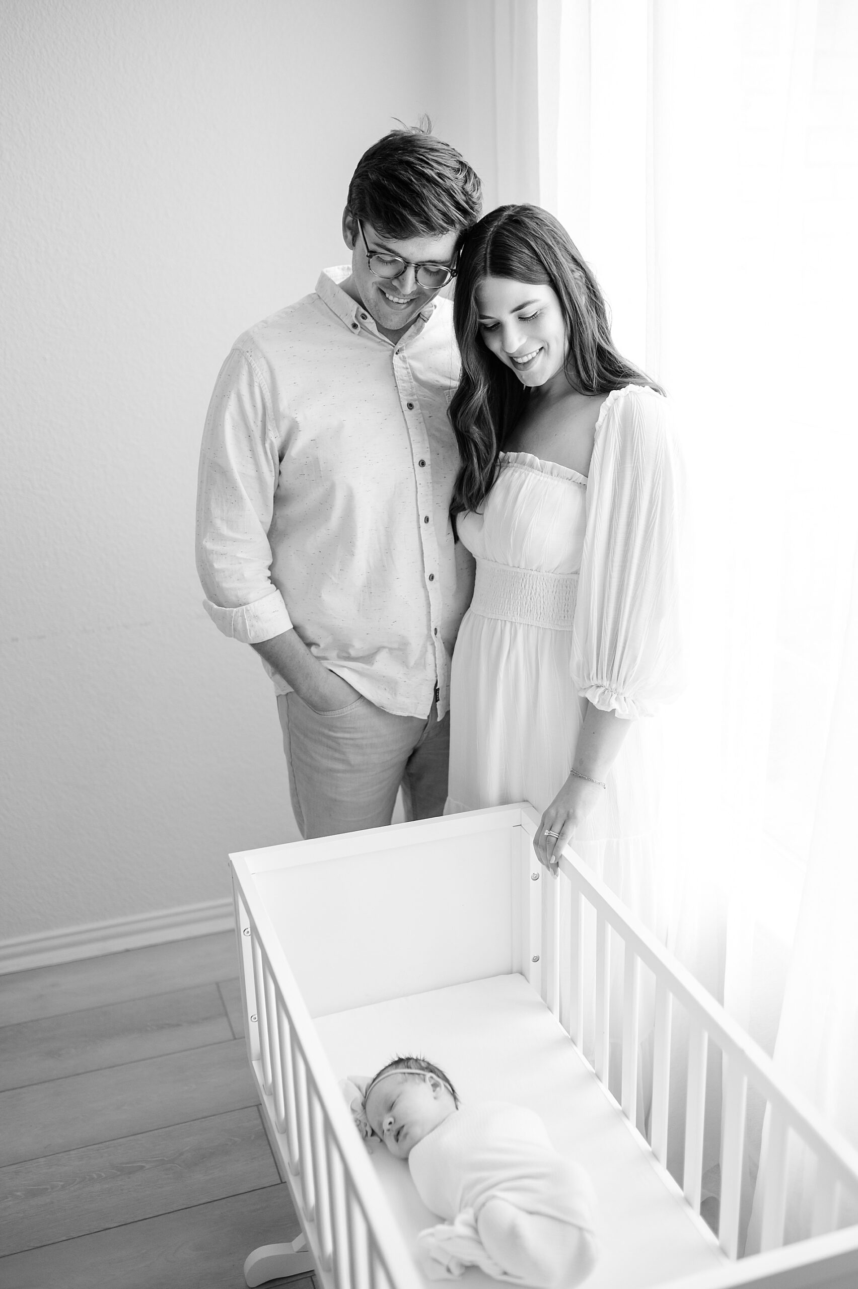 new parents look down on newborn girl photographed by Lindsey Dutton Photography, a Dallas newborn photographer
