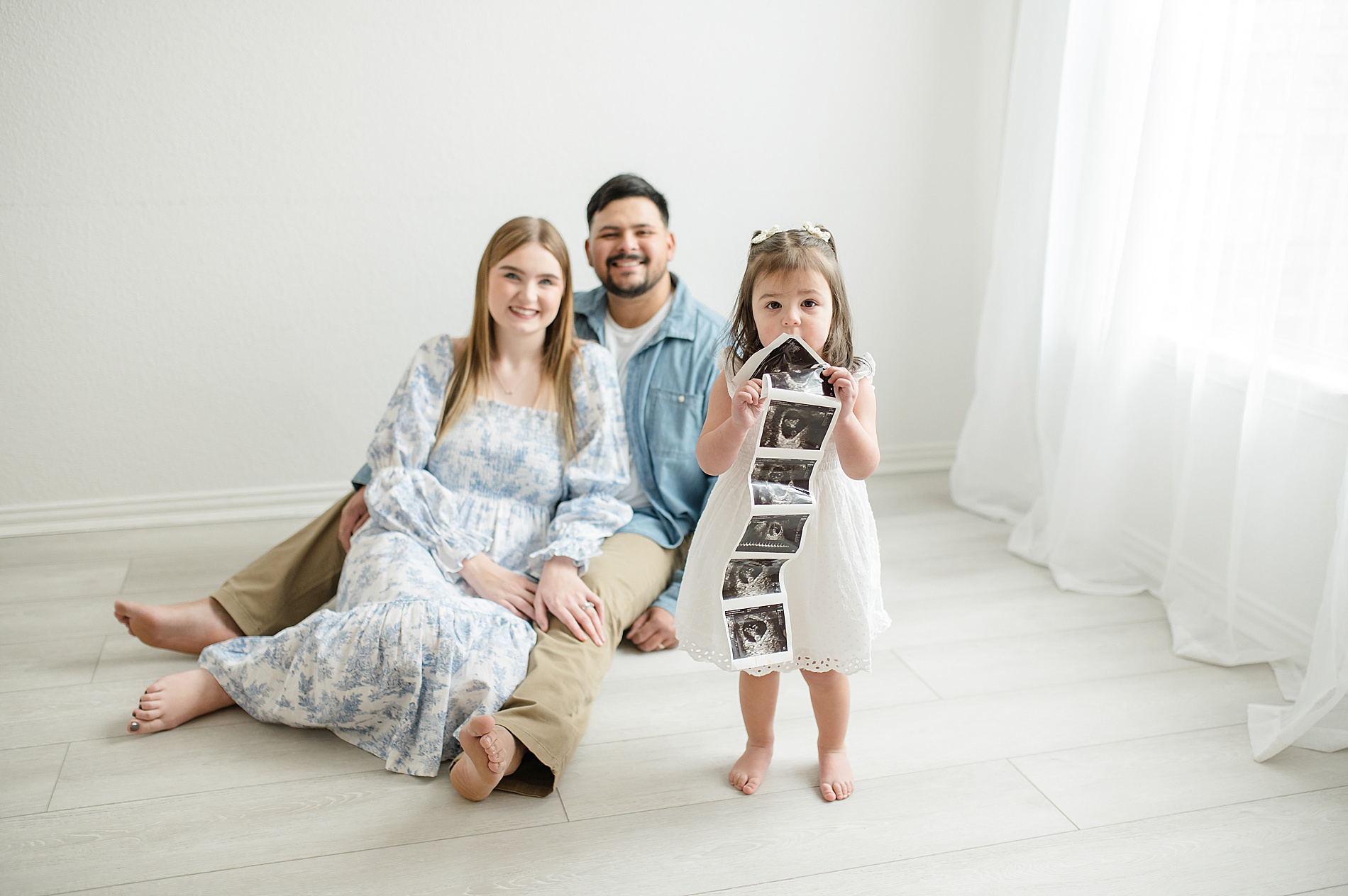 family of three moments before gender reveal photographed by Lindsey Dutton Photography, a Dallas Maternity photographer