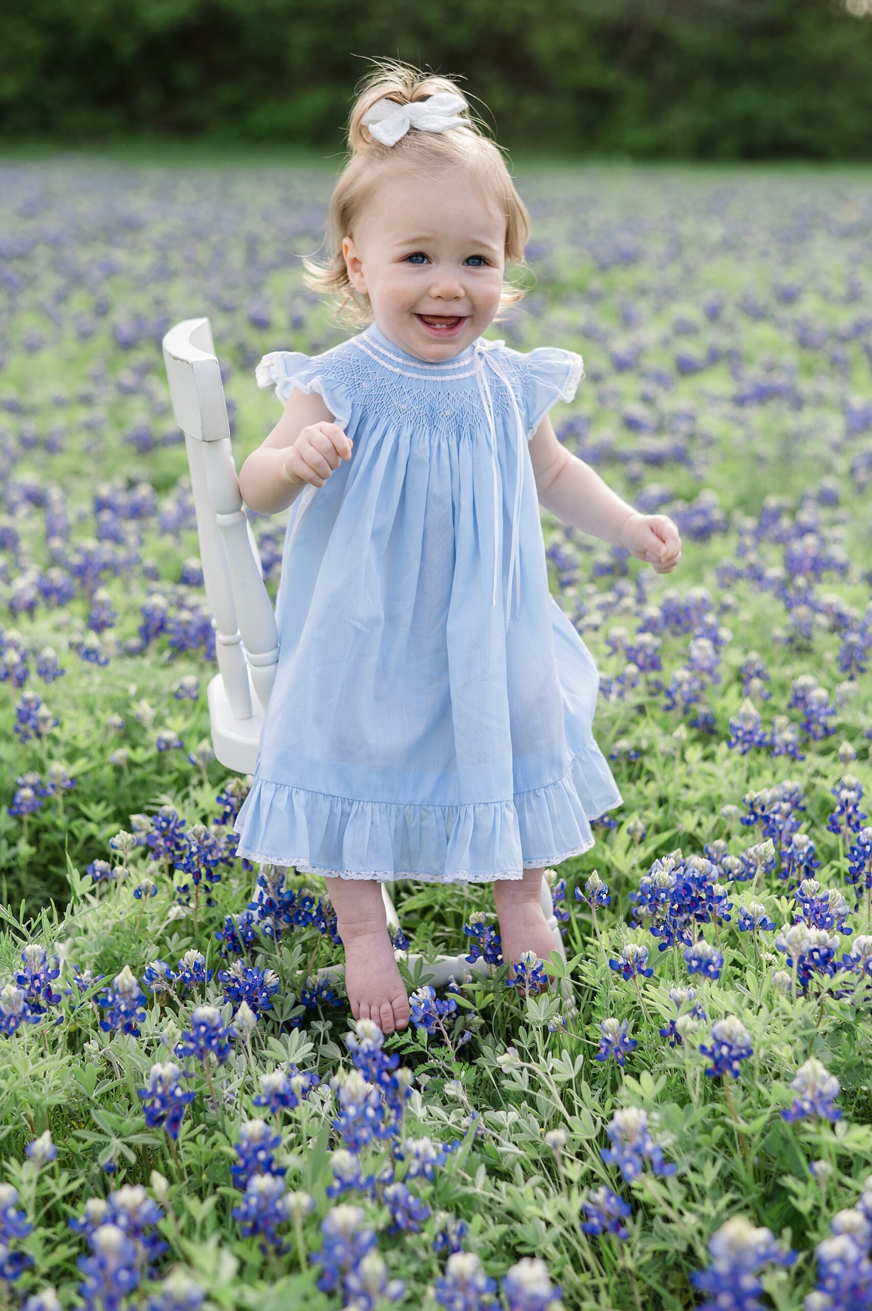 candid portraits of little girl in Dallas Texas field of Bluebonnet  photographed by Lindsey Dutton Photography, a Dallas family photographer