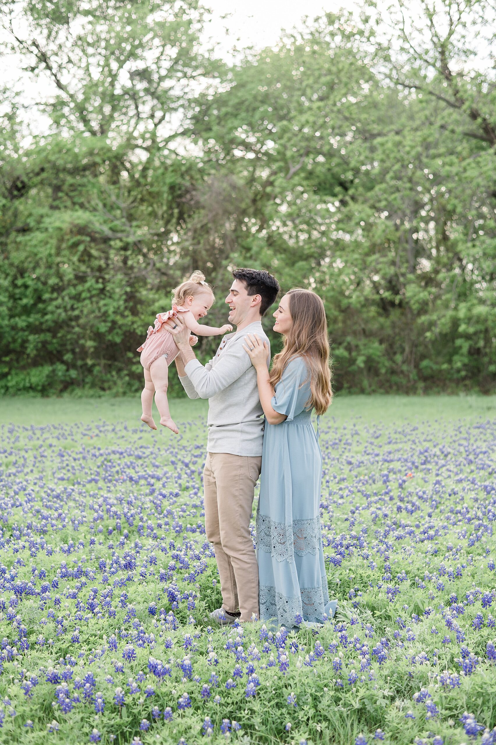 family of three during Dallas Texas Bluebonnet family Photos taken by Lindsey Dutton Photography, a Dallas family photographer