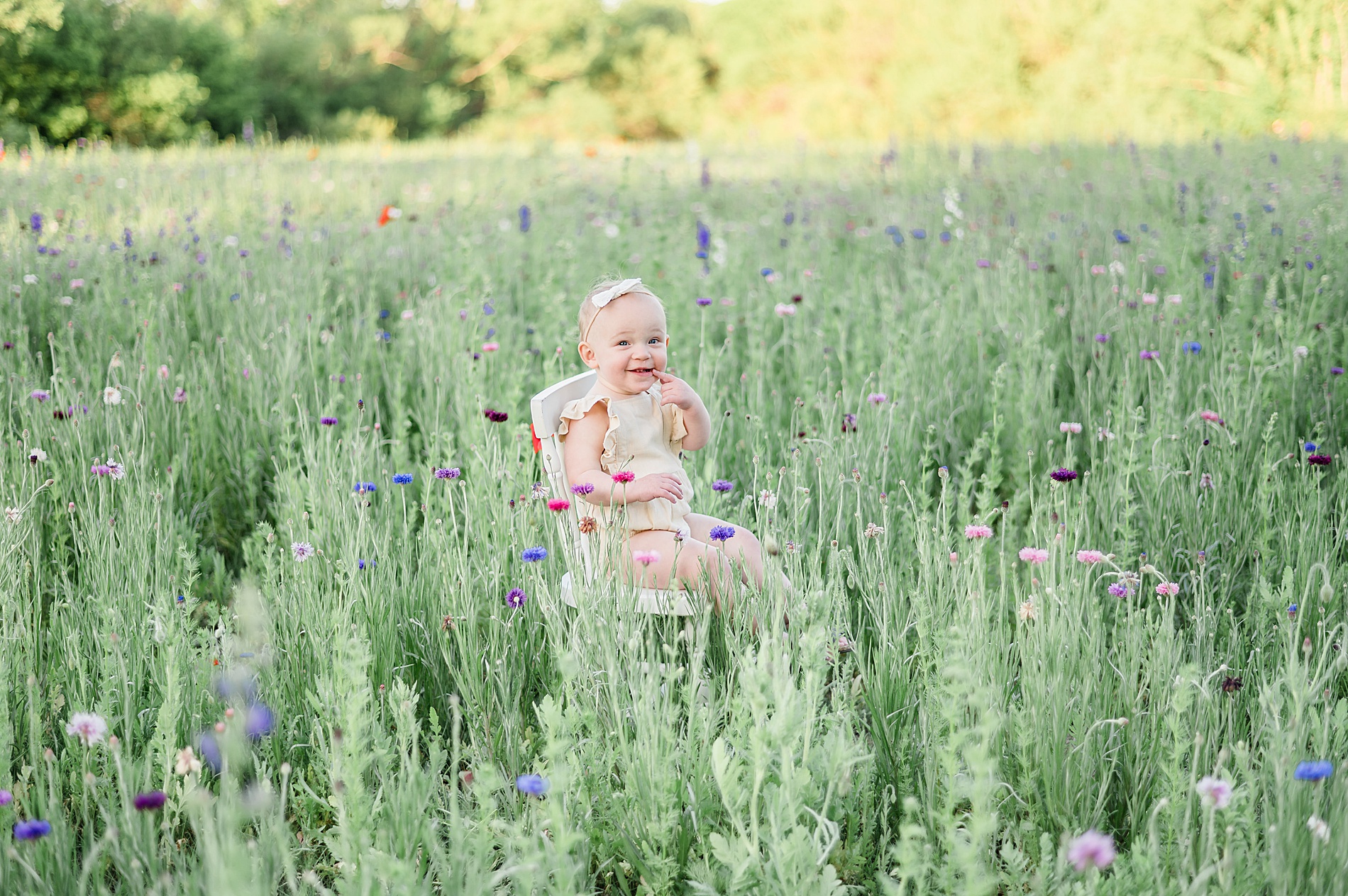 little girl in field of wildflowers during spring family session photographed by Lindsey Dutton Photography, a Dallas family photographer