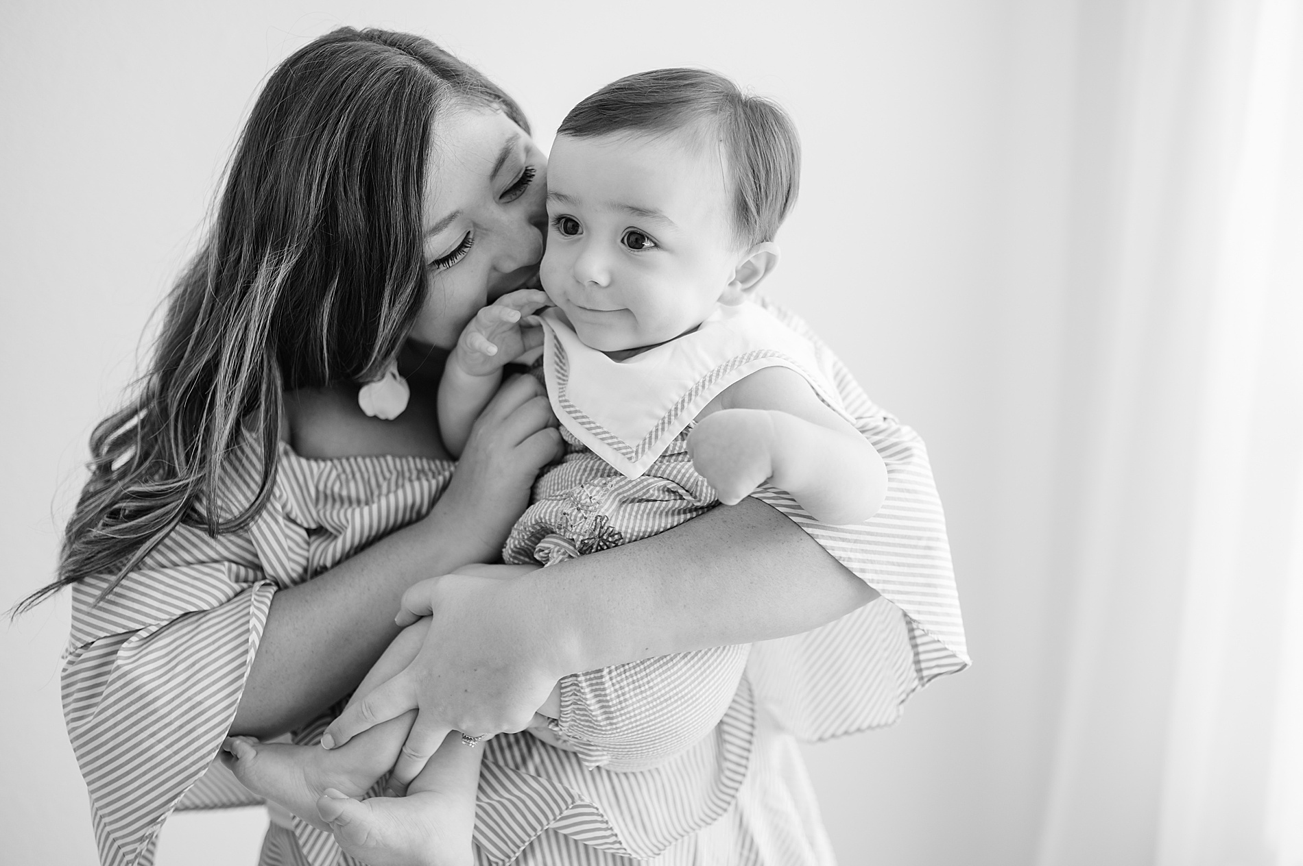 mom kisses son in timeless 1 year milestone session taken by Lindsey Dutton Photography, a Dallas newborn photographer
