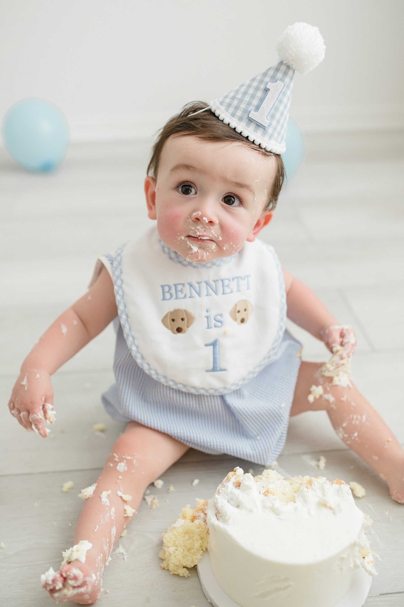 little boy covered in cake from cake smash session photographed by Lindsey Dutton Photography, a Dallas newborn photographer
