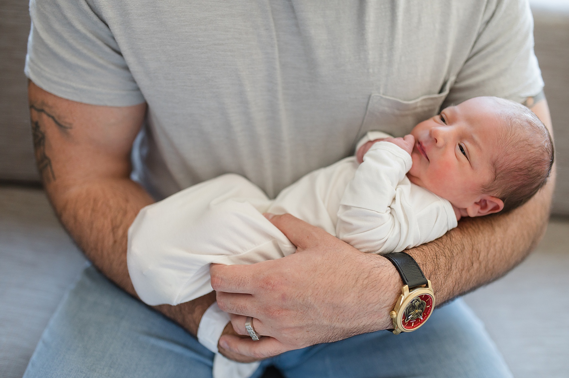dad holds newborn photographed by Lindsey Dutton Photography, a Dallas newborn photographer