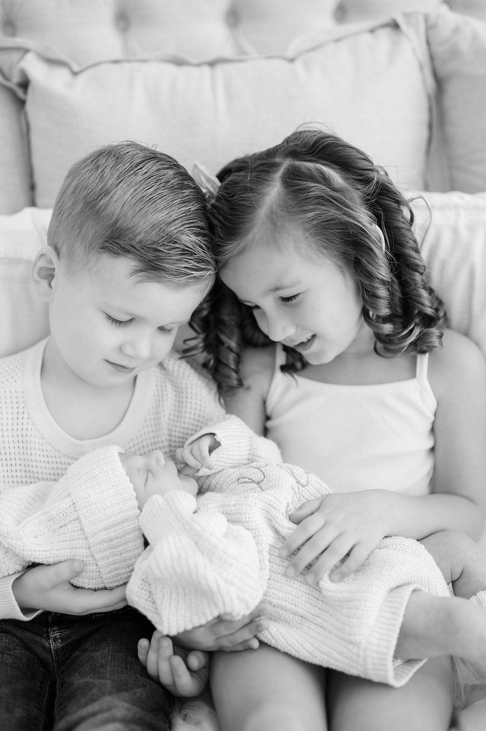 older siblings hold their baby brother photographed by Lindsey Dutton Photography, a Dallas newborn photographer
