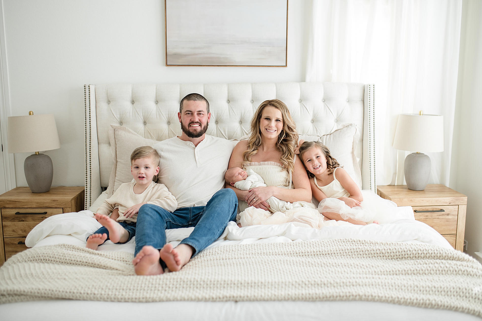 family portraits on bed taken by Lindsey Dutton Photography, a Dallas newborn photographer
