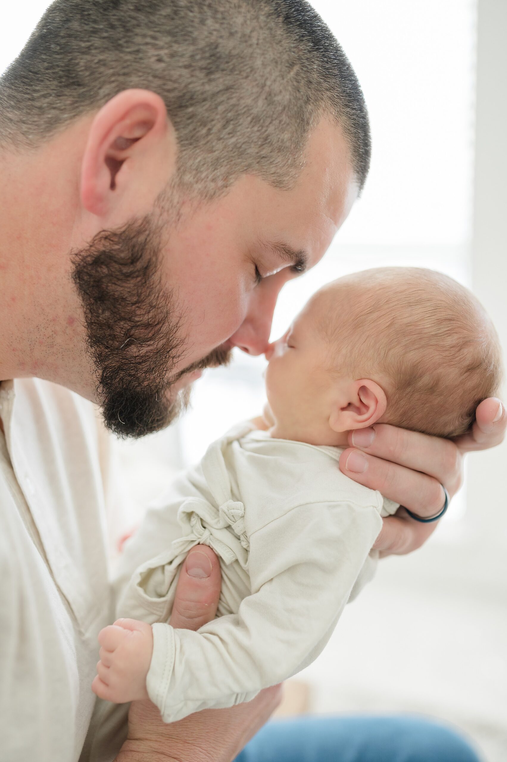 dad snuggles newborn boy taken by Lindsey Dutton Photography, a Dallas newborn photographer
