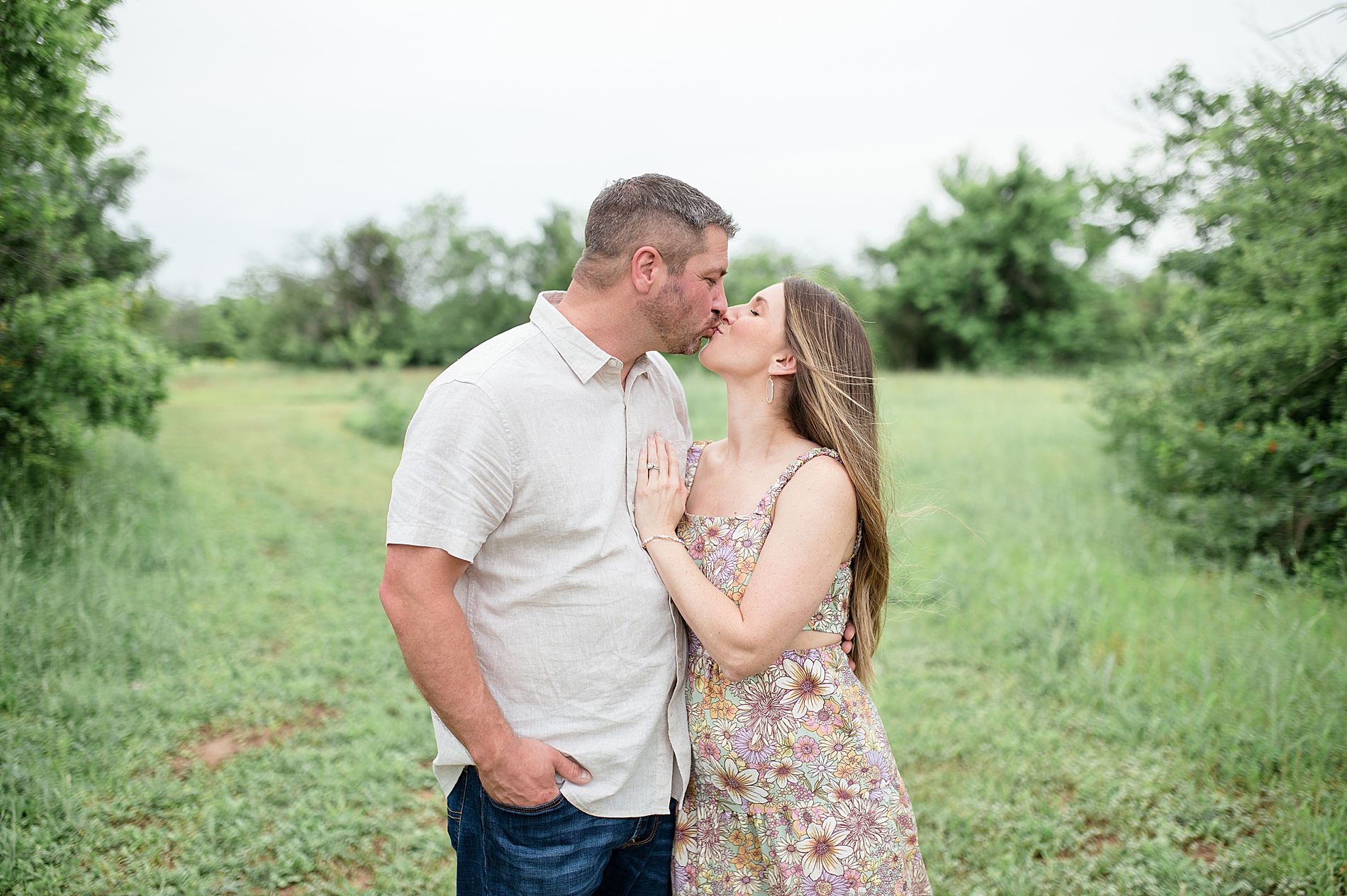 couple kisses during family session in Dallas Texas photographed by Lindsey Dutton Photography, a Dallas family photographer
