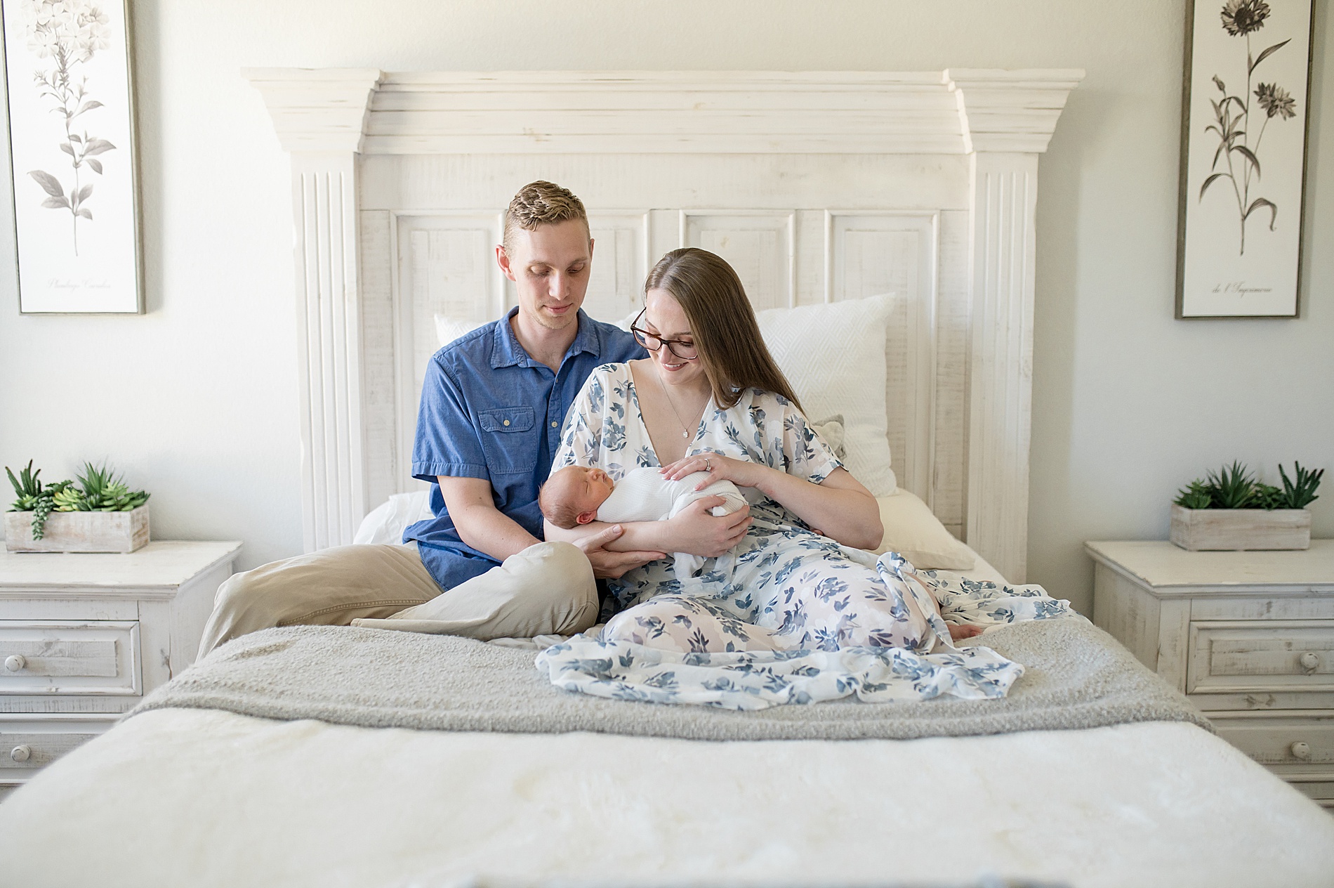 parents hold their newborn swaddled in blanket taken by Lindsey Dutton Photography, a Dallas newborn photographer
