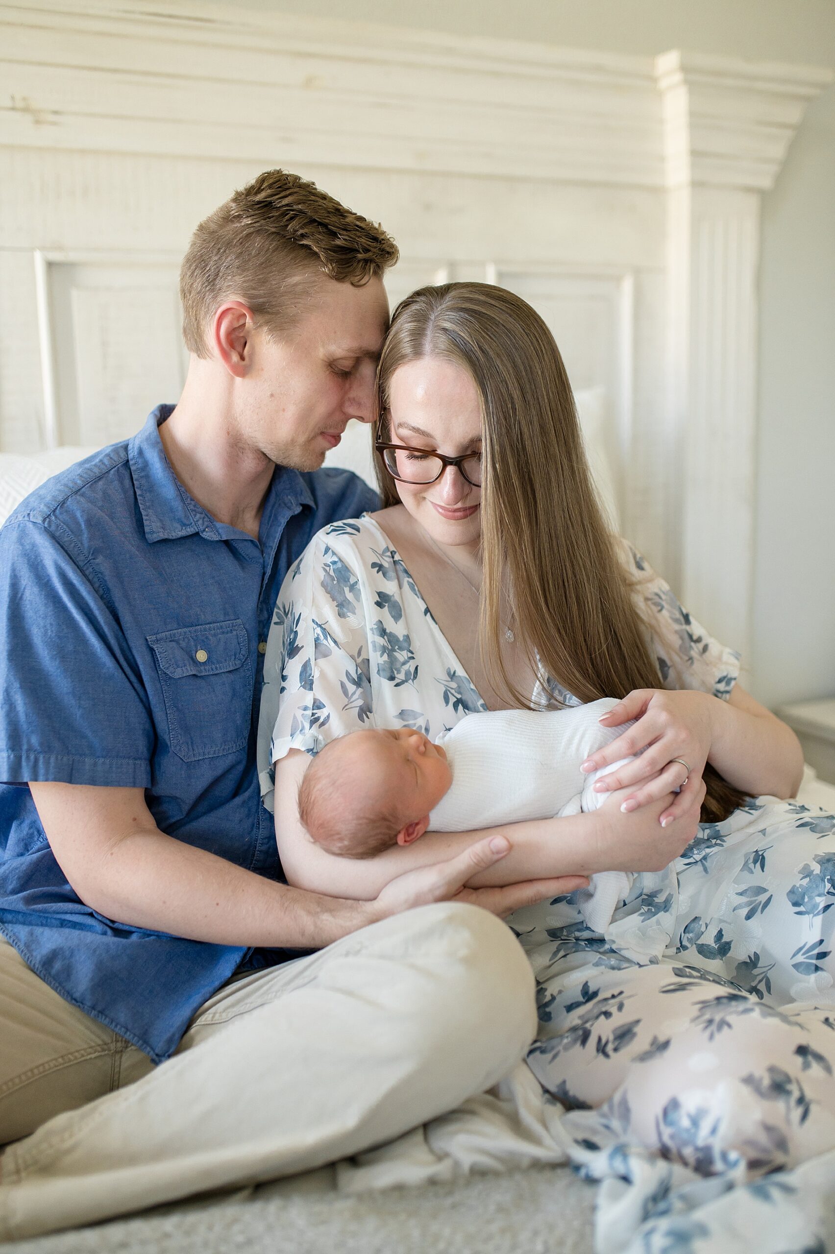 parents hold their swaddled newborn taken by Lindsey Dutton Photography, a Dallas newborn photographer
