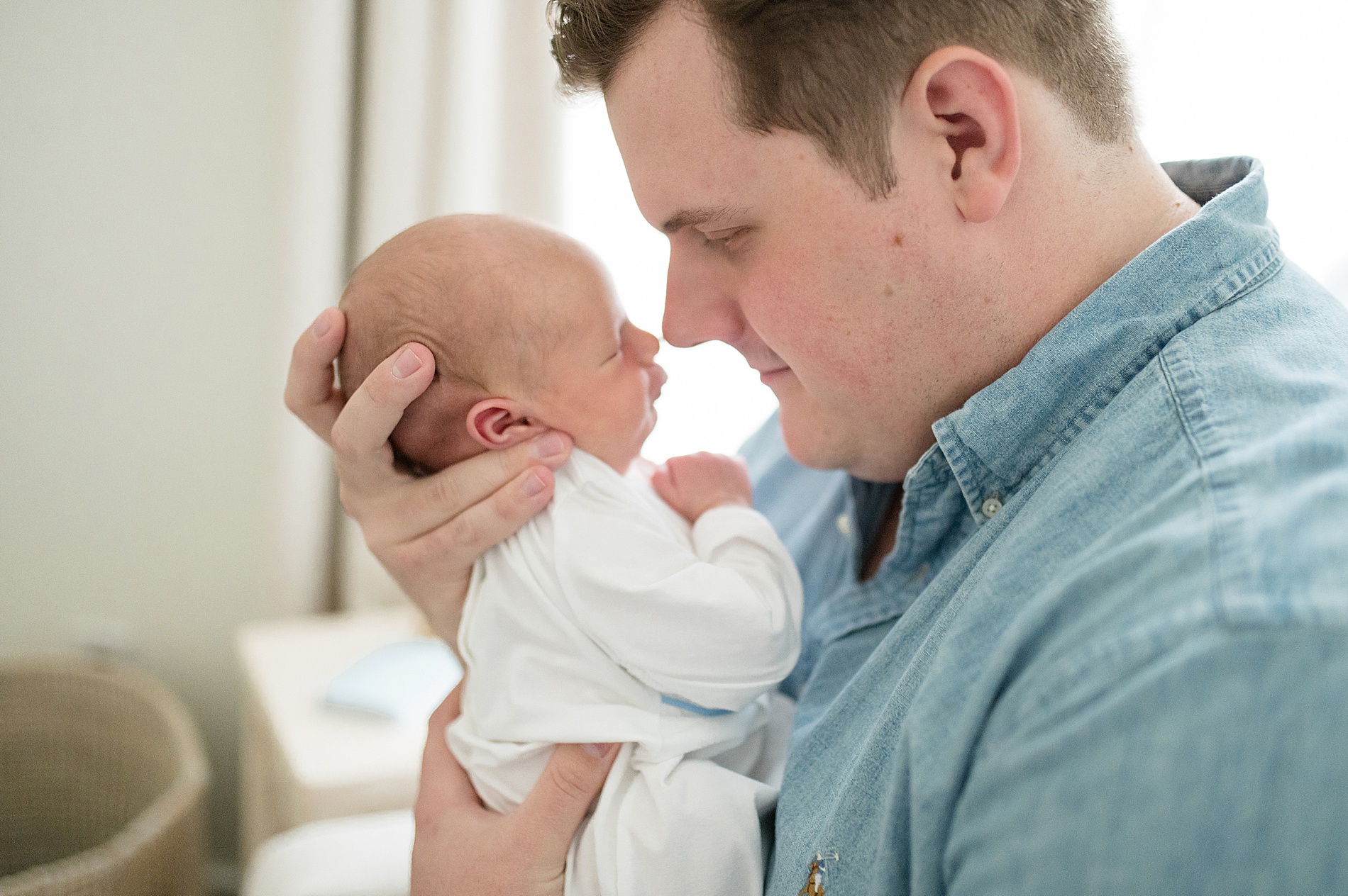 dad holds newborn unswaddled photographed by Lindsey Dutton Photography, a Dallas newborn photographer
