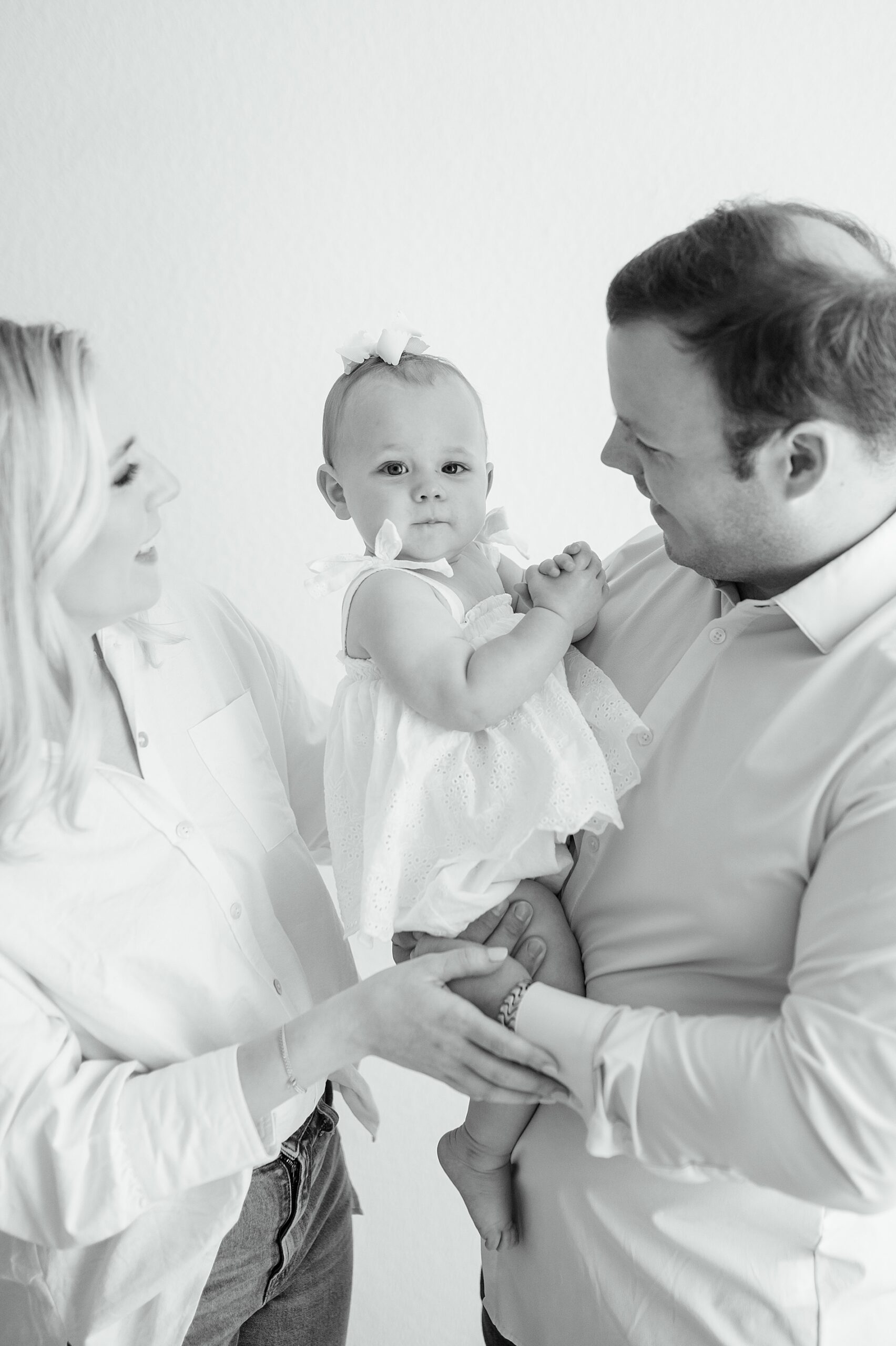 Classic look of white shirts and jeans for family photos taken by Lindsey Dutton Photography, a Dallas family photographer
