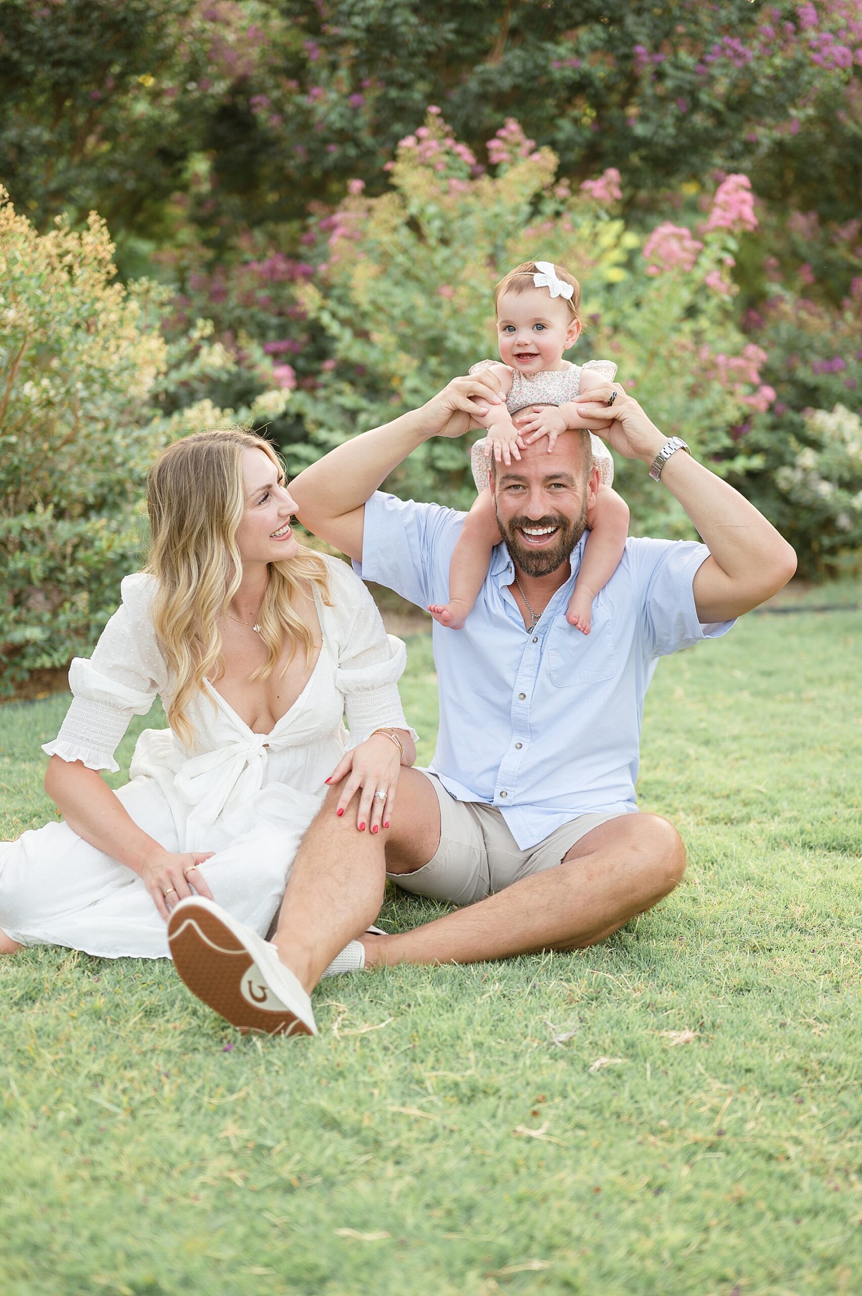 dad puts baby girl on shoulders photographed by Lindsey Dutton Photography, a Dallas family photographer
