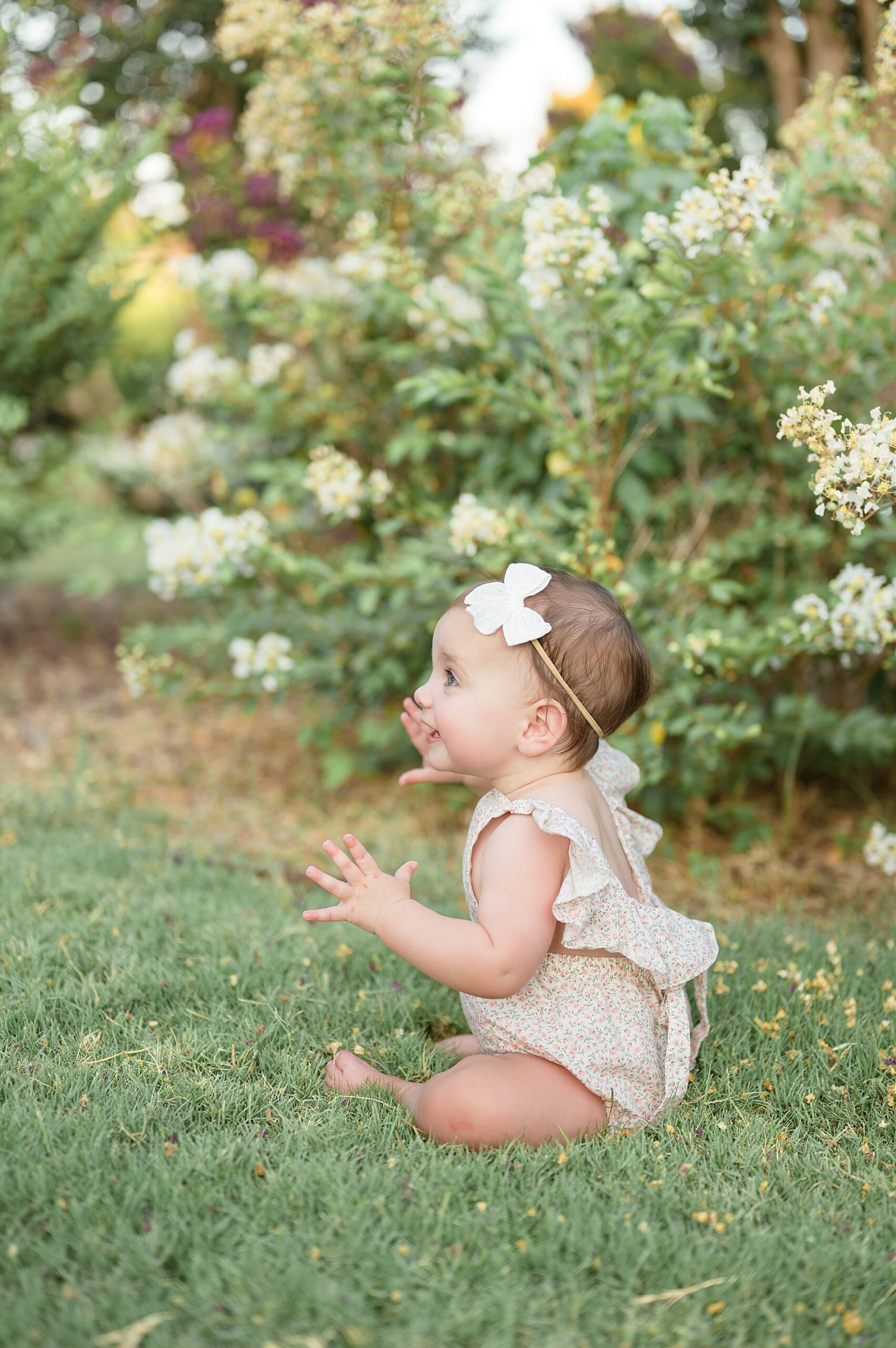 little girl in grass from Summer Crepe Myrtle Family Session photographed by Lindsey Dutton Photography, a Dallas family photographer
