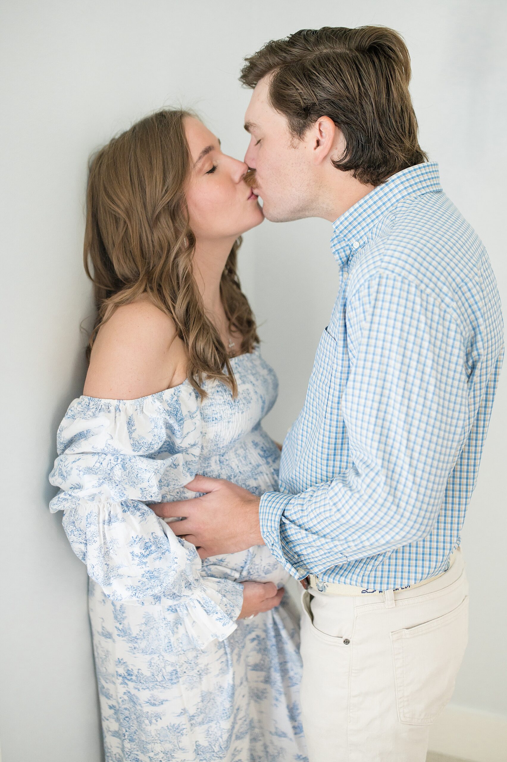 couple kiss during Dallas maternity session at their home taken by Lindsey Dutton Photography, a Dallas Maternity photographer
