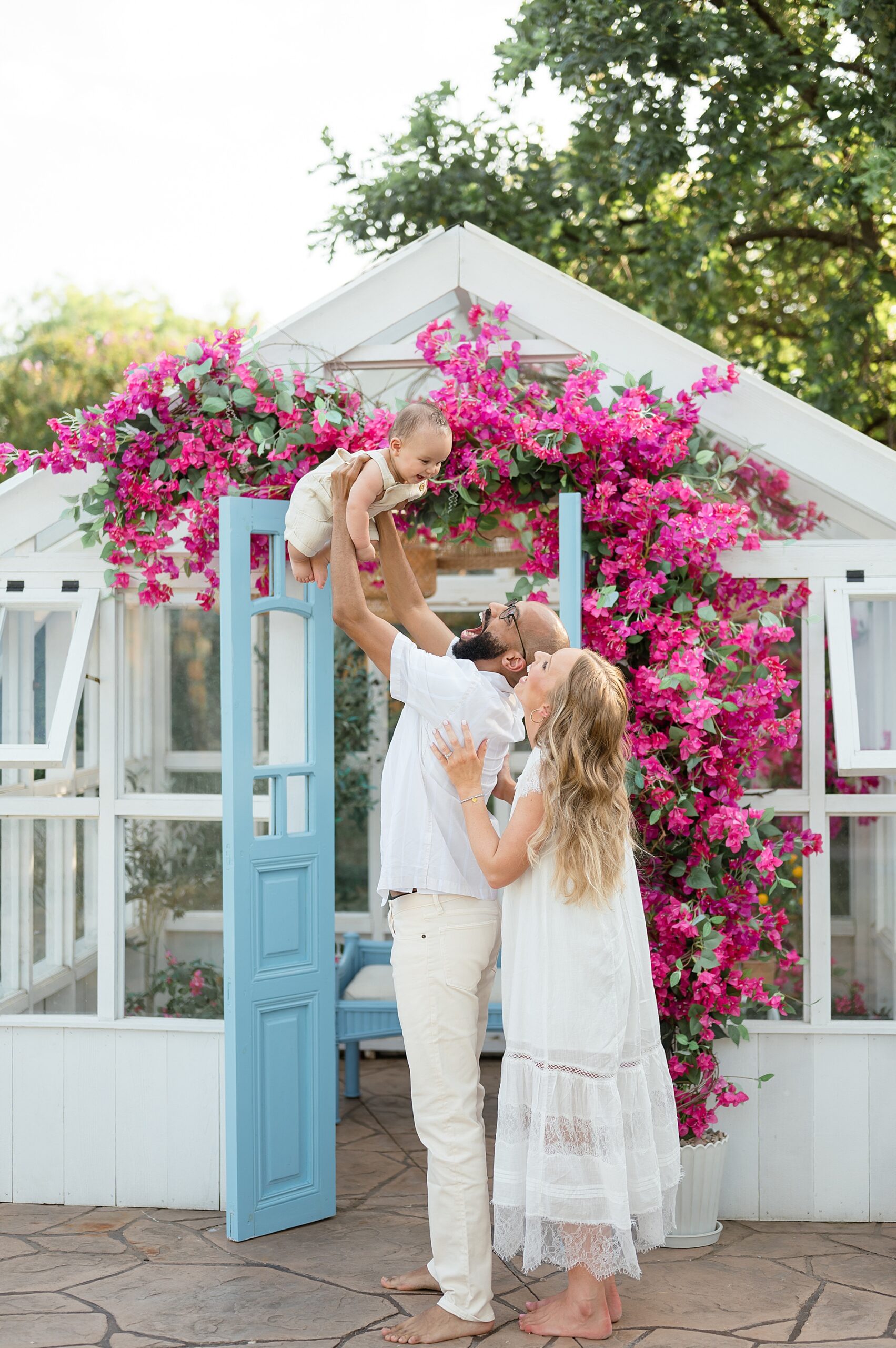 parents lift baby up during family photos in McKinney Texas photographed by Lindsey Dutton Photography, a Dallas Family photographer
