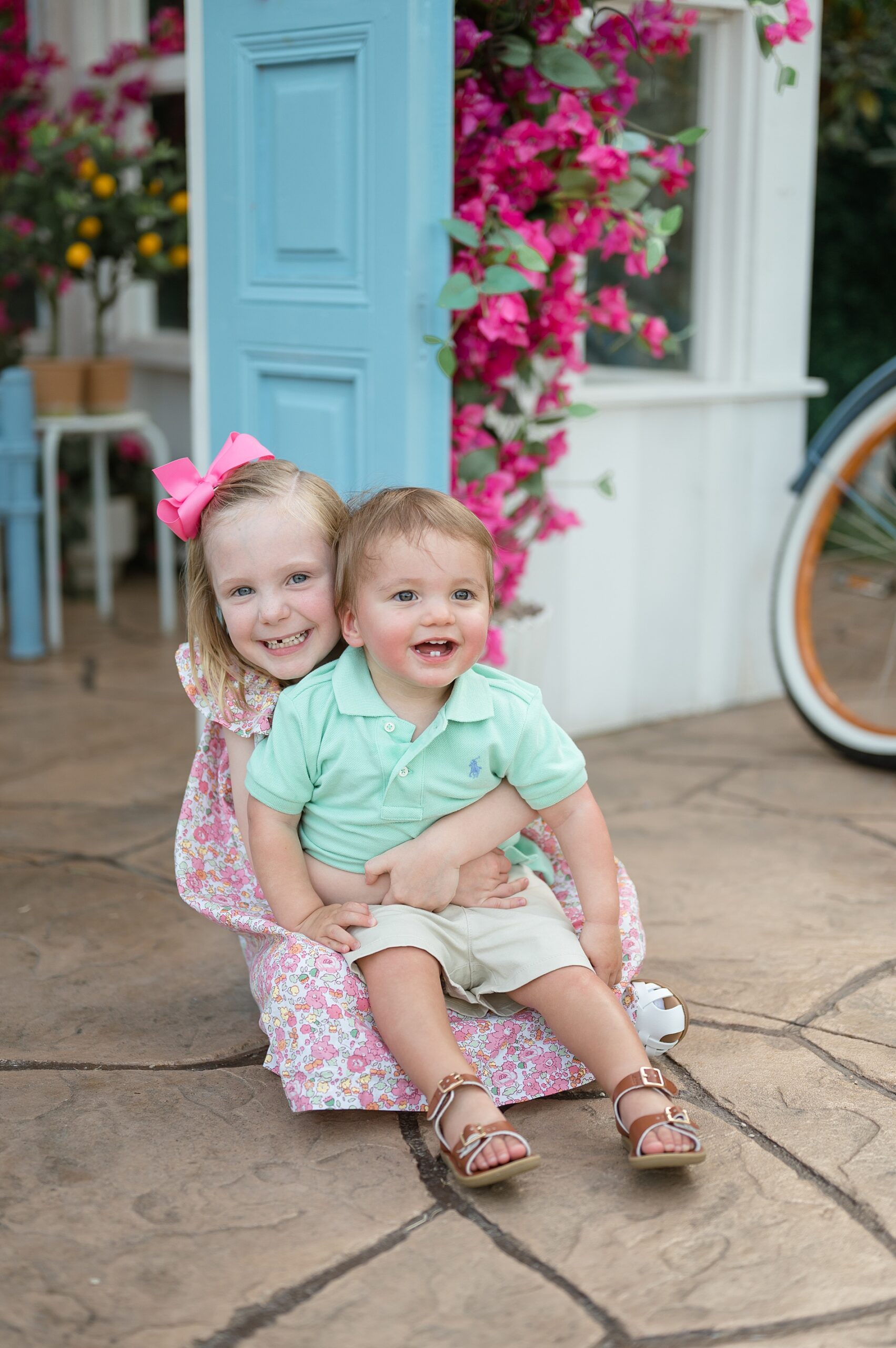 siblings hug during Timeless Greenhouse Photoshoots taken by Lindsey Dutton Photography, a Dallas Family photographer
