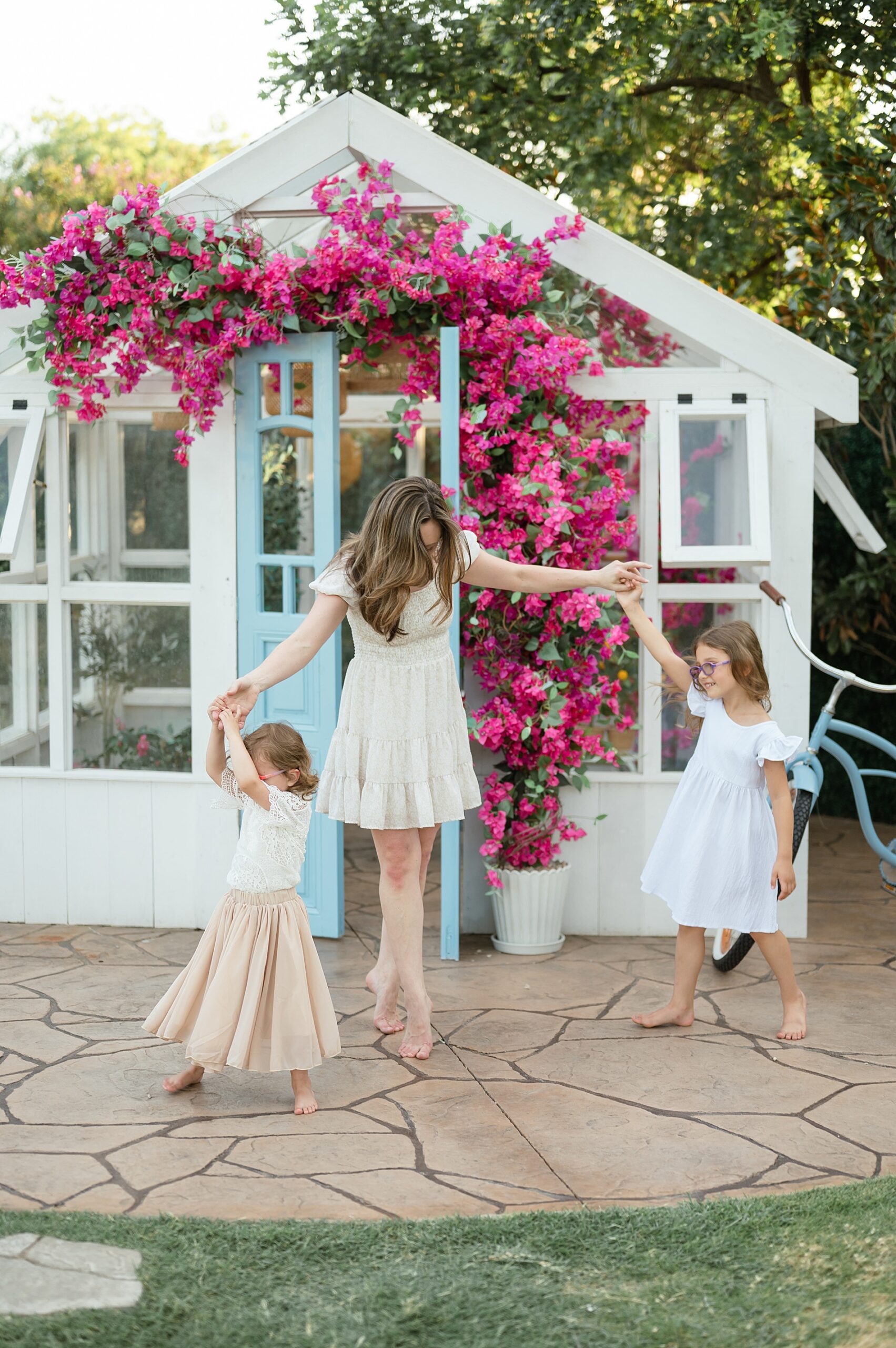 Mom and Daughters dancing at greenhouse at Lemon Drop Studios taken by Lindsey Dutton Photography, a Dallas Family photographer
 