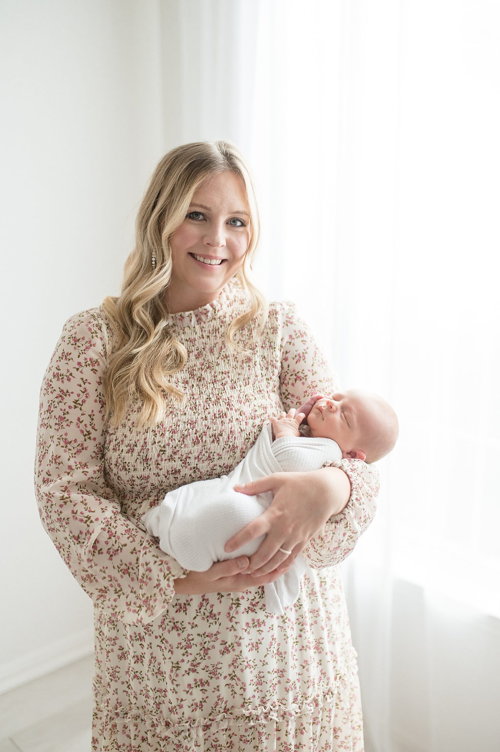 mom holds newborn son taken by Lindsey Dutton Photography, a Dallas Newborn photographer