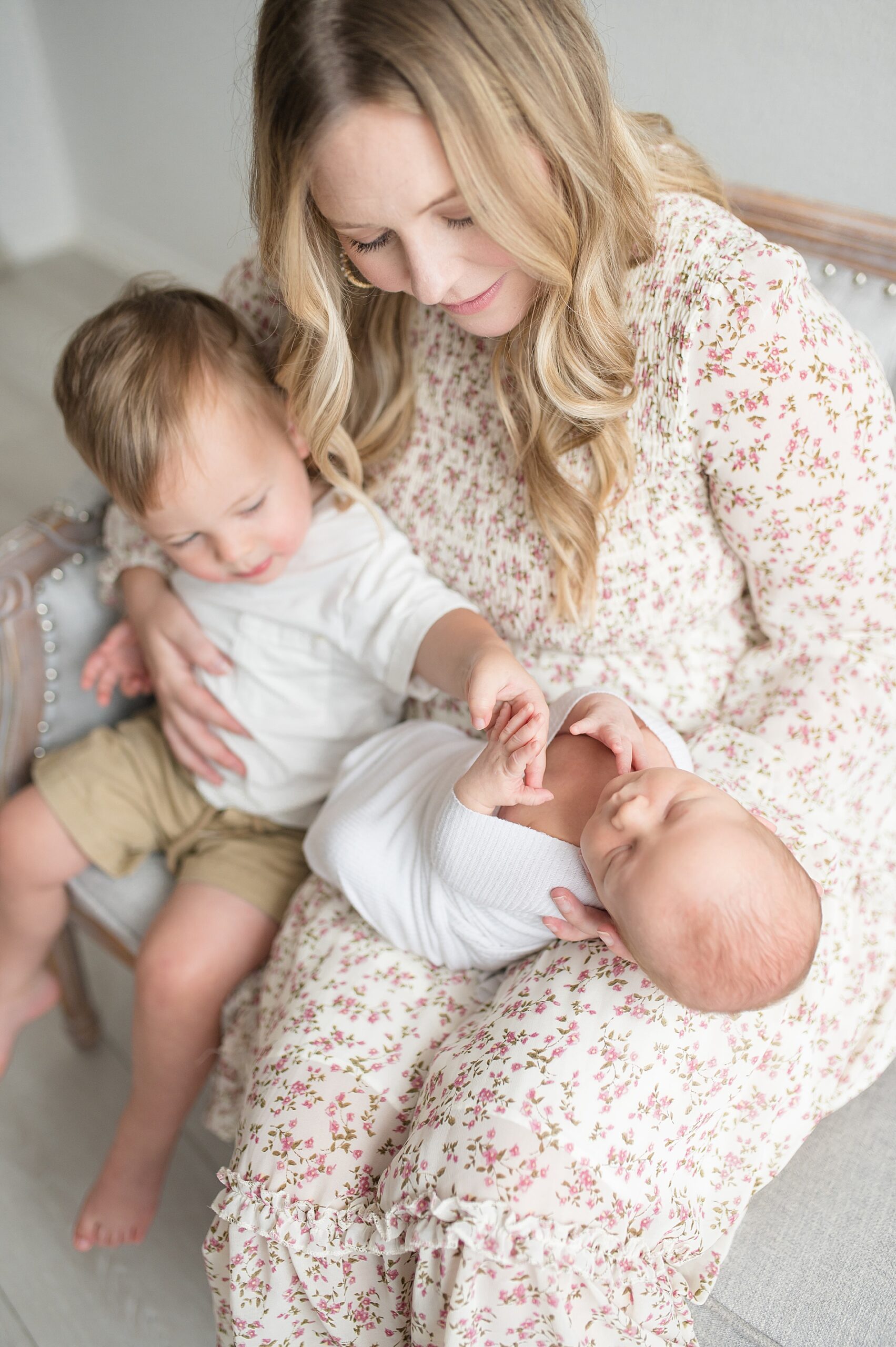 mom with her two sons during Simple Studio Newborn Session photographed by Lindsey Dutton Photography, a Dallas Newborn photographer