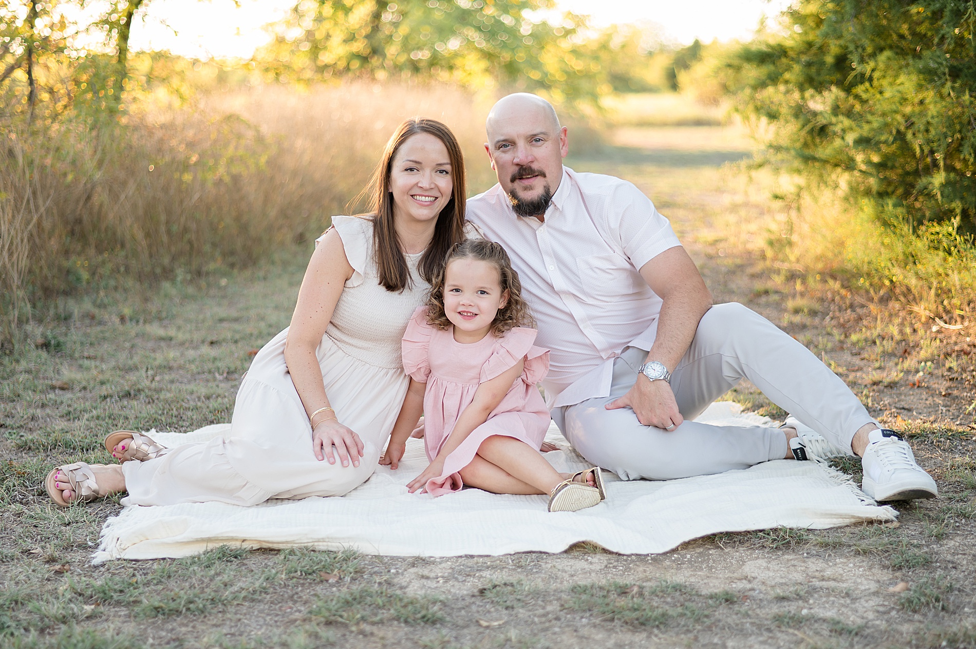 family of three sits together on blanket  taken by Lindsey Dutton Photography, a Dallas Family photographer | Choosing the Right Photography Package for Your Family