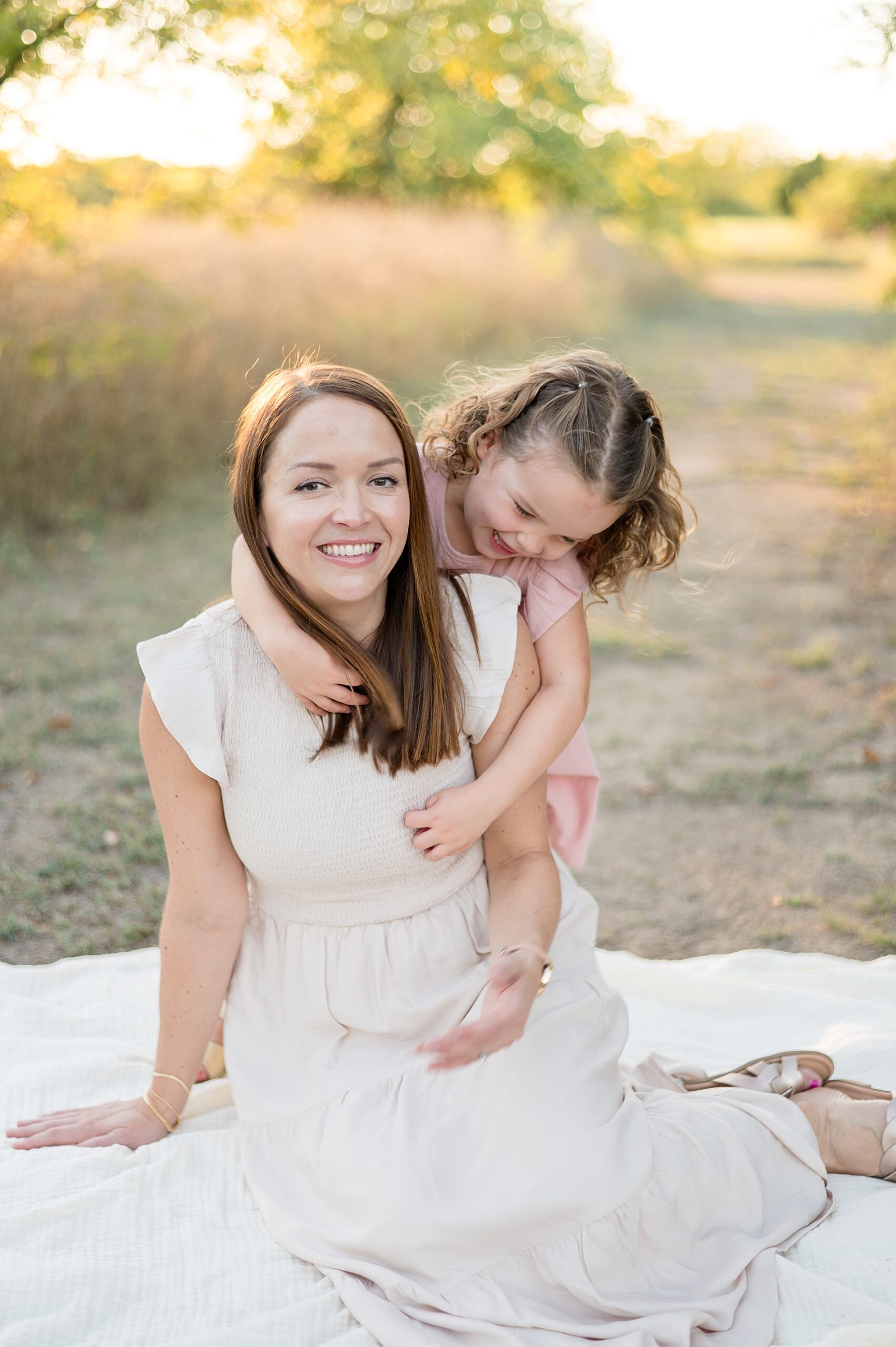 little girl hugs mom from behind photographed by Lindsey Dutton Photography, a Dallas Family photographer
