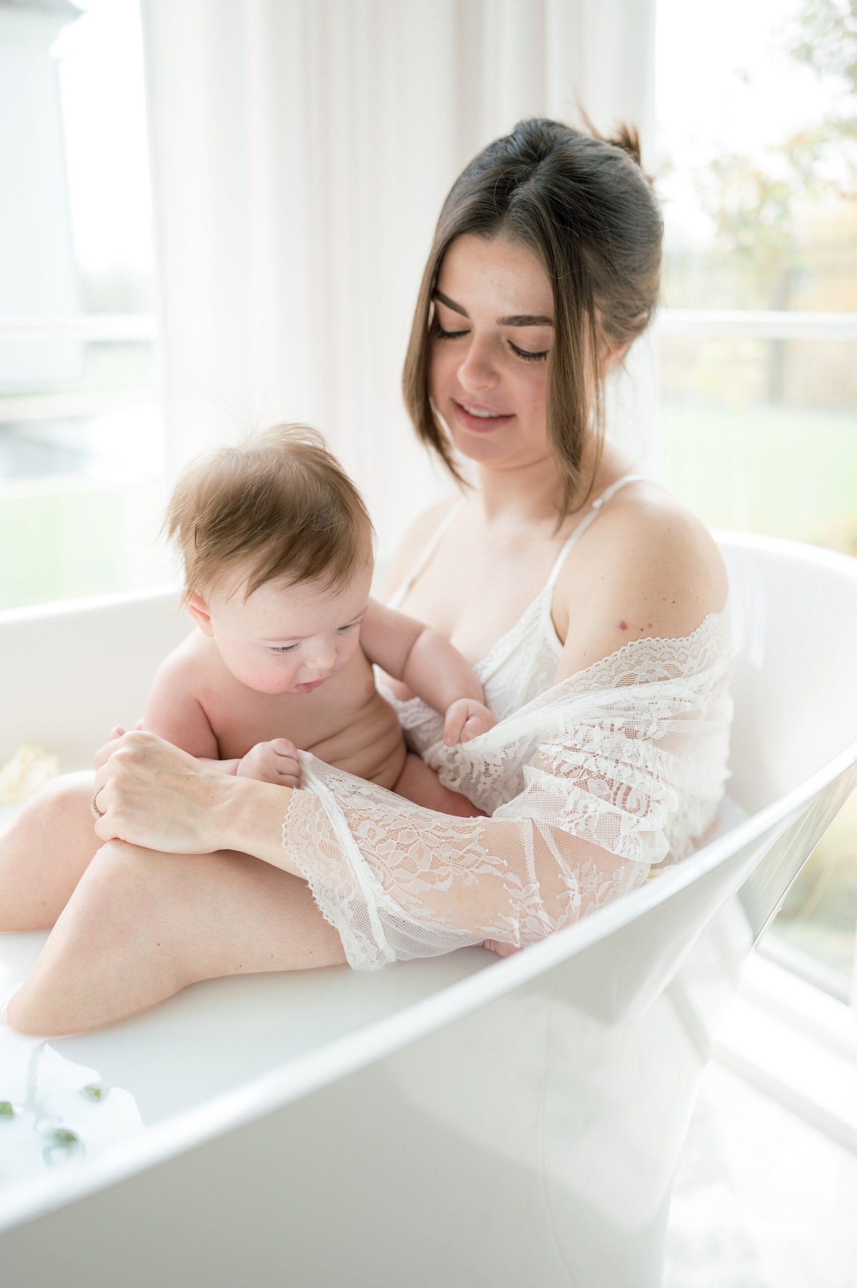 mom holds baby during 3 Month Milestone Milk bath Session by Milestone Photographer in Dallas Texas