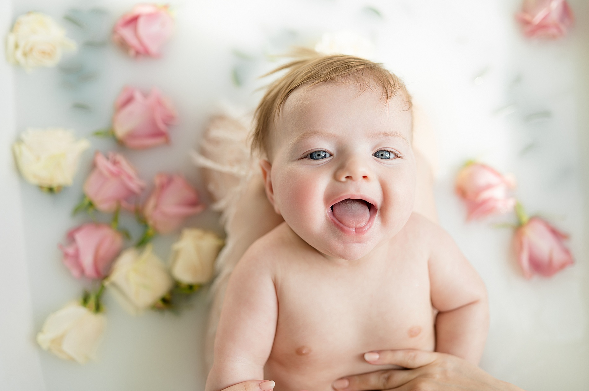 happy 3 month old smiles during milestone milk bath session by milestone photographer in Texas