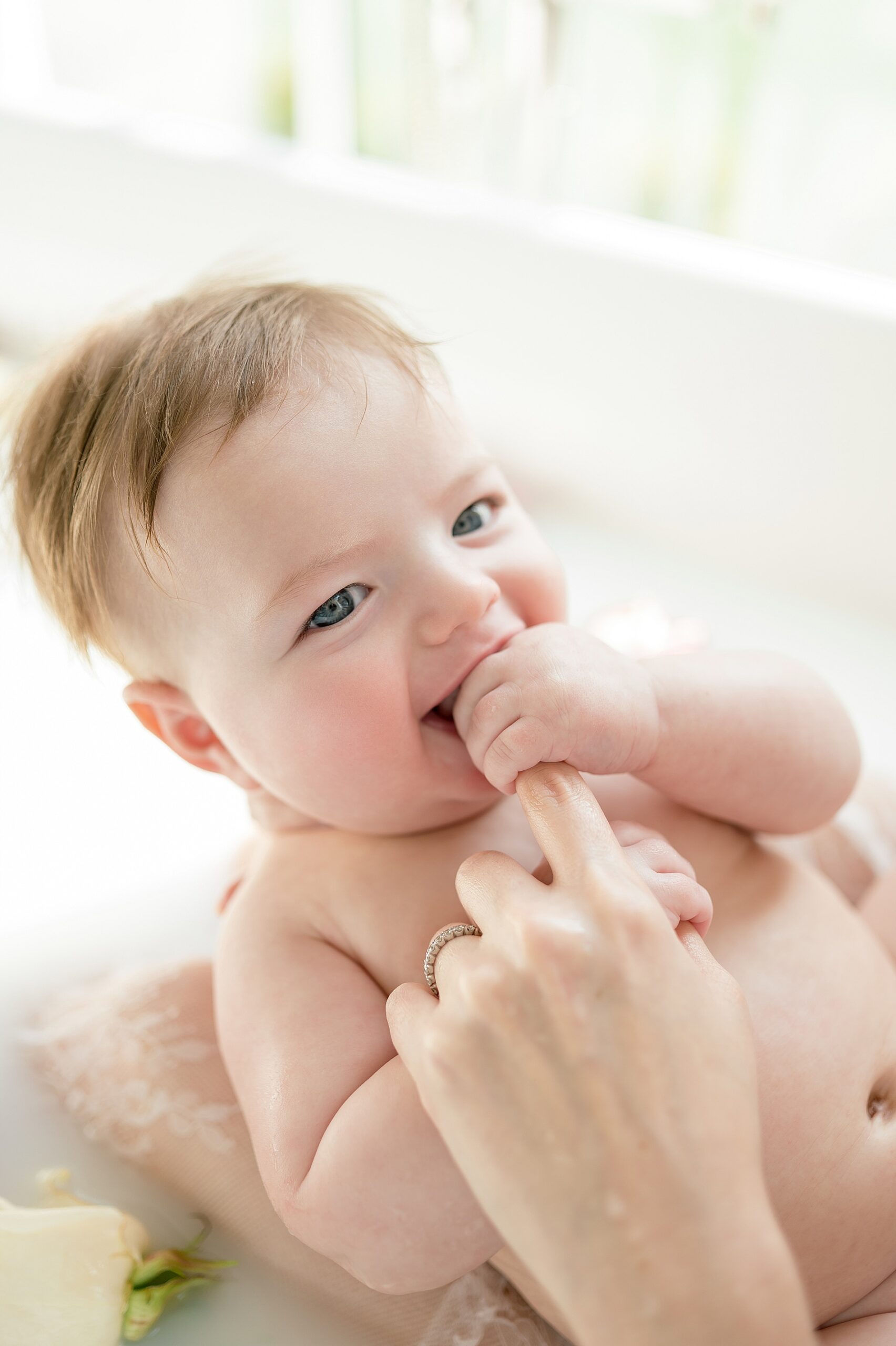 baby grabs mom's finger 