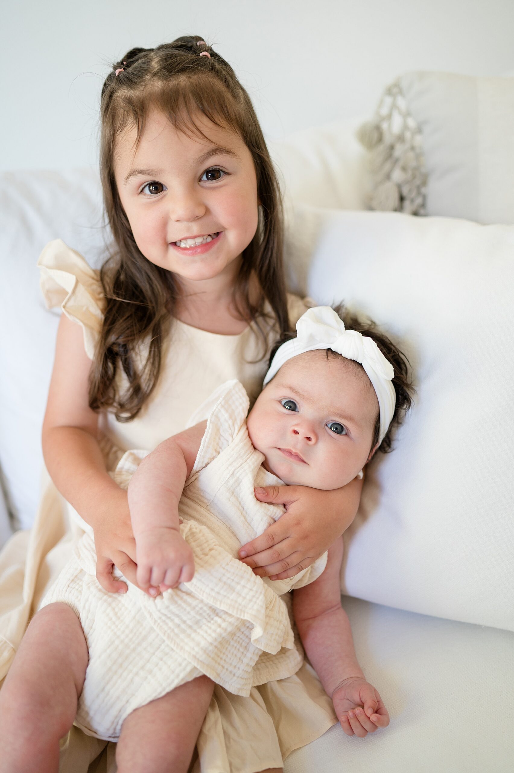 big sister holds baby sister by McKinney, TX Family Photographer