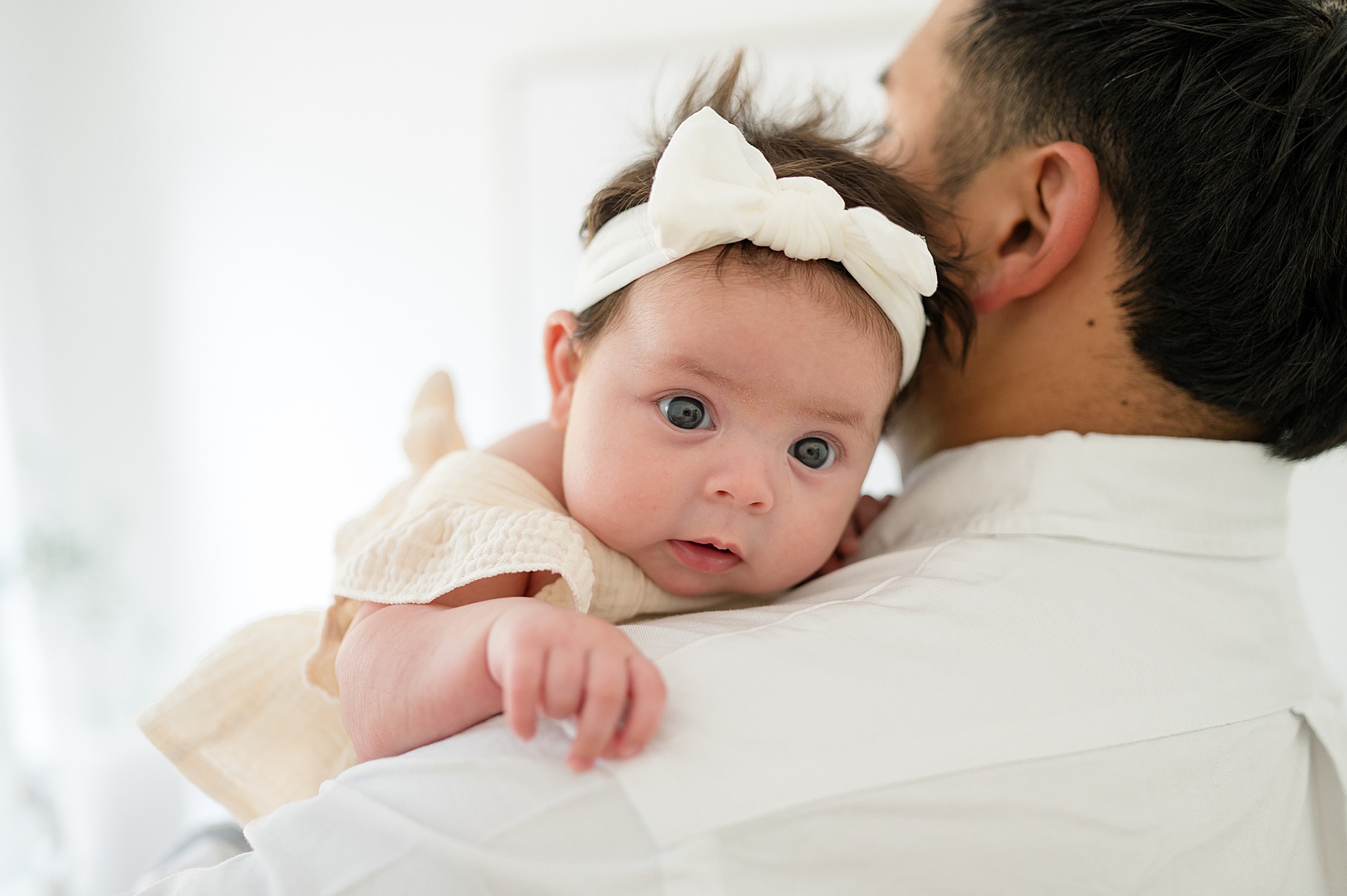 dad holds baby girl  